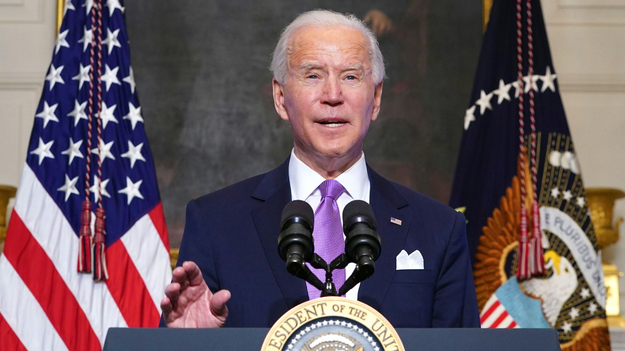 US President Joe Biden speaks on Covid-19 response in the State Dining Room of the White House in Washington, DC on January 26, 2021. - The number of confirmed coronavirus cases around the world on January 26 passed 100 million since the start of the pandemic, according to an AFP tally.