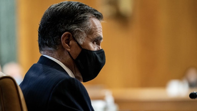 Senator Mitt Romney, a Republican from Utah, center, wears a protective mask during a Senate Budget Committee confirmation hearing for Neera Tanden, director of the Office and Management and Budget (OMB) nominee for U.S. President Joe Biden, in Washington, D.C., U.S., on Wednesday, Feb. 10, 2021. Tanden apologized for partisan tweets, pledged to distribute stimulus checks quickly, and defended her stance on Wall Street and Silicon Valley's influence in yesterday's hearing on her nomination to lead the OMB. Photographer: Anna Moneymaker/The New York Times/Bloomberg