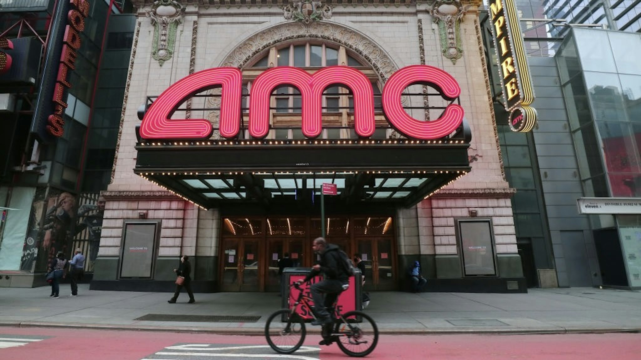 NEW YORK, NY - OCTOBER 22: A person rides his bicycle past the closed AMC movie theaters in Times Square on October 22, 2020 in New York City . (Photo by Gary Hershorn/Getty Images)
