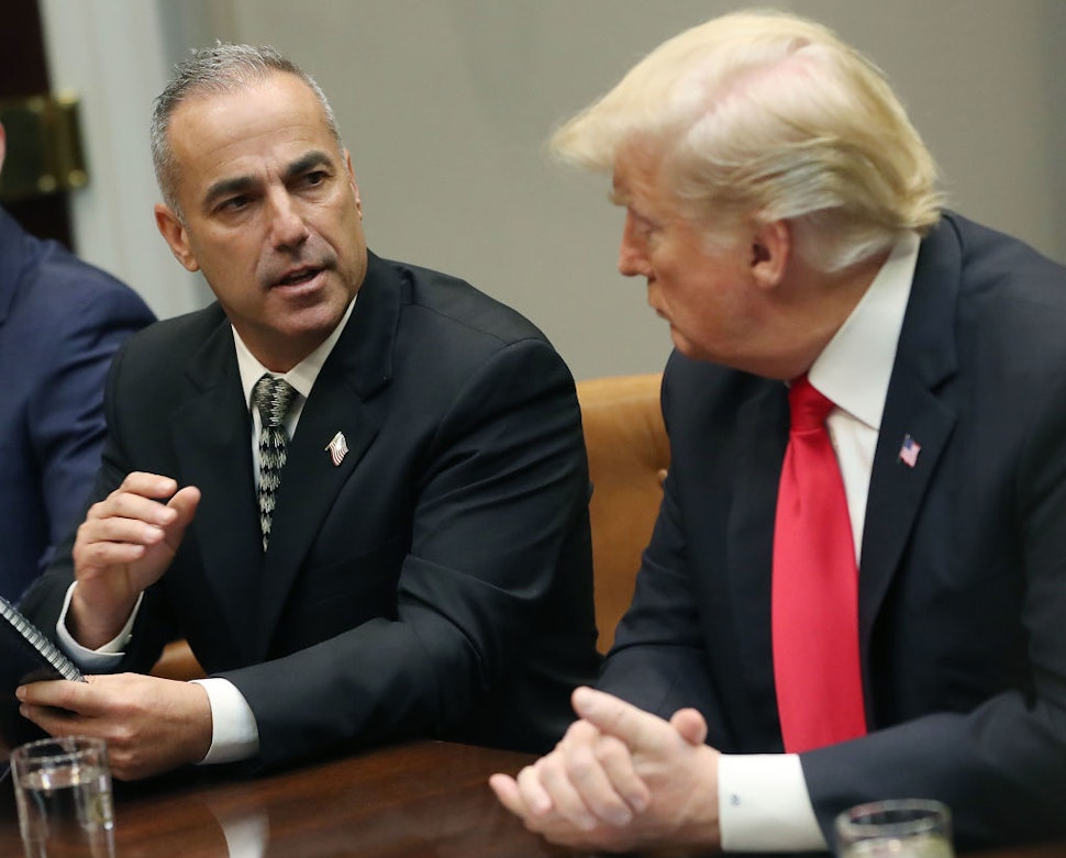 Andrew Pollack, whose daughter Meadow Pollack was killed in the mass shooting at Stoneman Douglas High School in Parkland, Florida, speaks to U.S. President Donald Trump about school safety and the new Federal Commission on School Safety report during a roundtable discussion with family members of shooting victims, alongside state and local officials, in the Roosevelt Room at the White House on December 18, 2018 in Washington, DC.