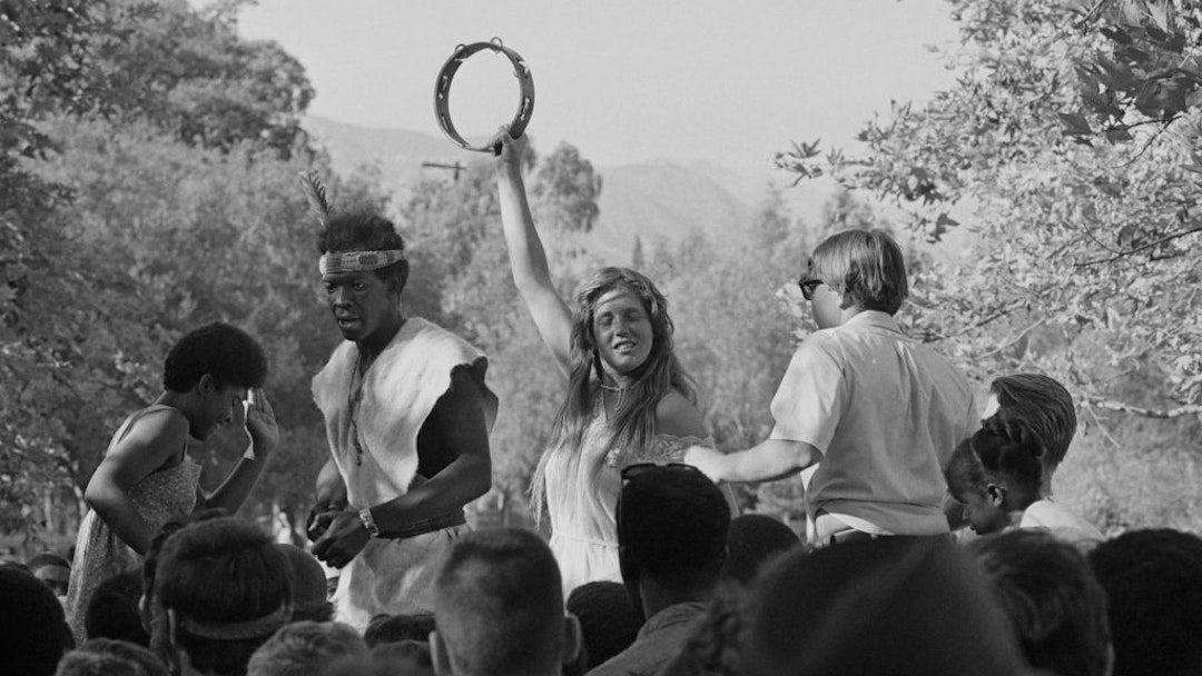 People dancing and playing a at a tambourine at a love-in held at Griffith Park, Los Angeles, US, 1967. (Photo by Graphic House/Hulton Archive/Getty Images)