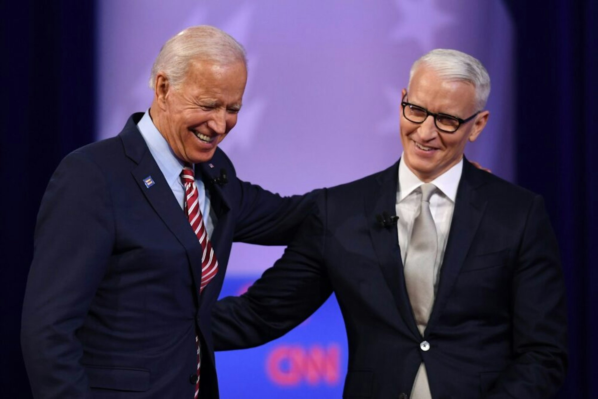 Democratic presidential hopeful former US Vice President Joe Biden (L) laughs with moderator CNN's Anderson Cooper during a town hall devoted to LGBTQ issues hosted by CNN and the Human rights Campaign Foundation at The Novo in Los Angeles on October 10, 2019.