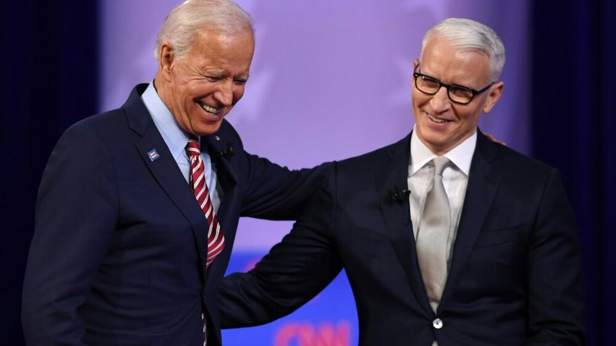 Democratic presidential hopeful former US Vice President Joe Biden (L) laughs with moderator CNN's Anderson Cooper during a town hall devoted to LGBTQ issues hosted by CNN and the Human rights Campaign Foundation at The Novo in Los Angeles on October 10, 2019.