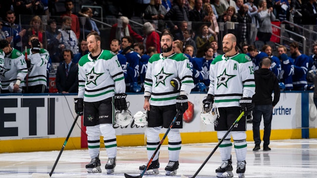 Radek Faksa #12, Roman Polak #45 and Blake Comeau #15 of the Dallas Stars stand for the national anthems before the start o the first period against the Toronto Maple Leafs at the Scotiabank Arena on February 13, 2020 in Toronto, Ontario, Canada.