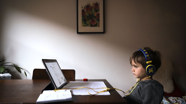 SYDNEY, AUSTRALIA - MAY 21: Six-year-old Kaya Atayman sits in front of his computer as he does homeschooling at his home in the suburb of Bondi on May 21, 2020 in Sydney, Australia. Students in New South Wales return to regular lessons today, after a week of staggered lessons, as COVID-19 restrictions ease across Australia. (Photo by David Gray/Getty Images)