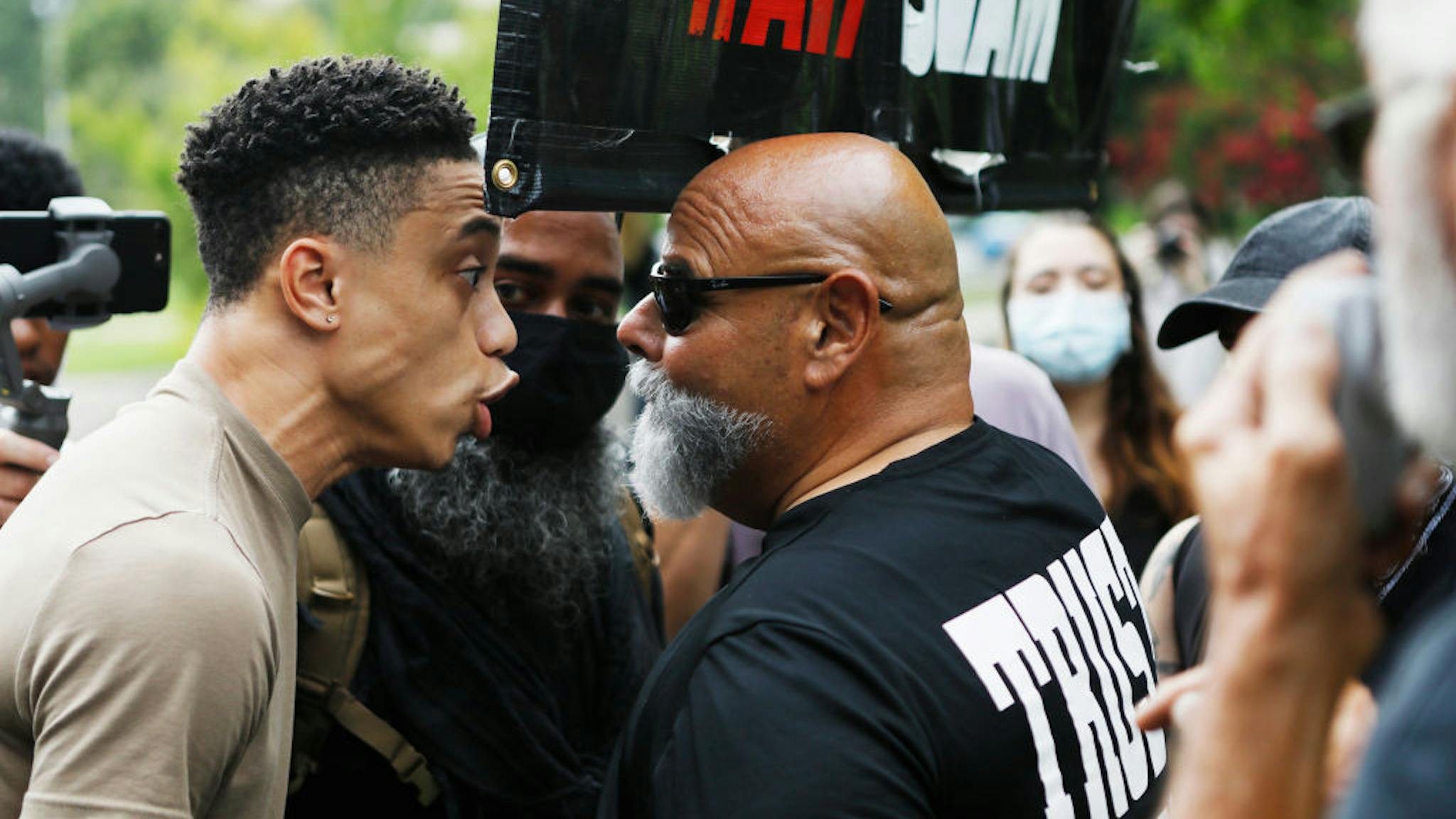Republicans Hold Virtual 2020 National Convention CHARLOTTE, NC - AUGUST 24: Republican National Convention protesters and counter protesters clash at the Resist RNC 2020 protest rally at Marshall Park on August 24, 2020 in uptown Charlotte, North Carolina. The Republican Party holds their national convention during the coronavirus (COVID-19) pandemic. (Photo by Octavio Jones/Getty Images)