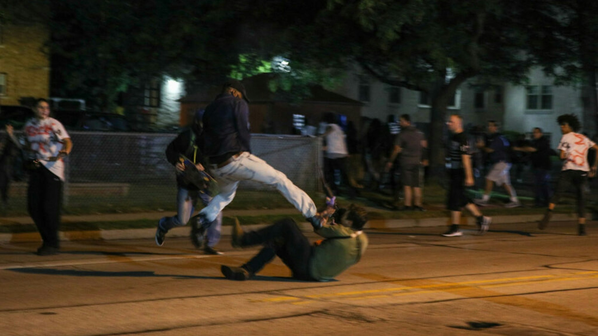 KENOSHA, WISCONSIN, USA - AUGUST 25: (EDITORS NOTE: Image contains graphic content.) A protester clashes with armed civilian Kyle Rittenhouse during confrontations between protesters and armed civilians, who claimed to protect the streets of Kenosha against the arson, during the third day of protests over the shooting of a black man Jacob Blake by police officer in Wisconsin, United States on August 25, 2020. Kyle Rittenhouse has been charged by Wisconsin prosecutors with the killing of Anthony Huber, 26 and Joseph Rosenbaum, 36 and the injuring of Gaige Grosskreutz, also 26.