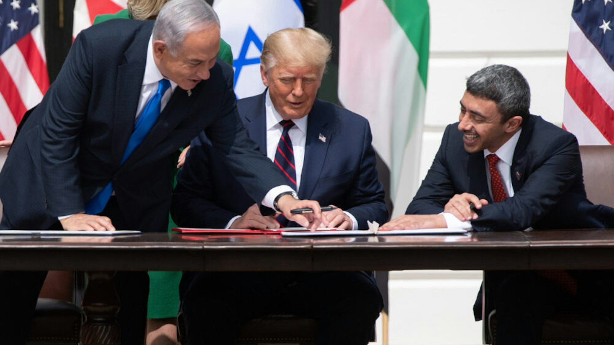 Israeli Prime Minister Benjamin Netanyahu(L), US President Donald Trump, and UAE Foreign Minister Abdullah bin Zayed Al-Nahyan(R)smile as they participate in the signing of the Abraham Accords where the countries of Bahrain and the United Arab Emirates recognize Israel, at the White House in Washington, DC, September 15, 2020. - Israeli Prime Minister Benjamin Netanyahu and the foreign ministers of Bahrain and the United Arab Emirates arrived September 15, 2020 at the White House to sign historic accords normalizing ties between the Jewish and Arab states.