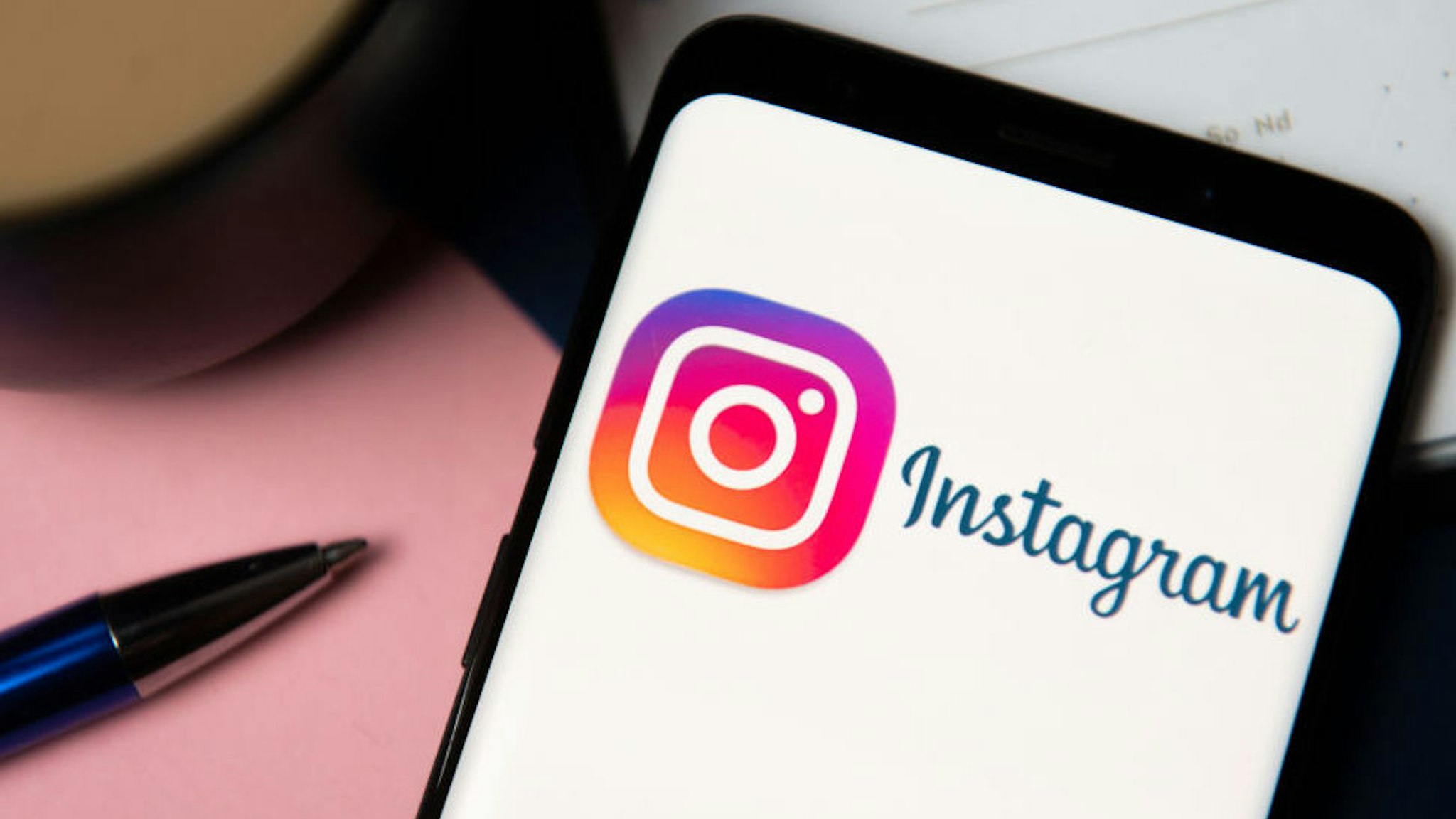 In this photo illustration an Instagram logo displayed on a smartphone.