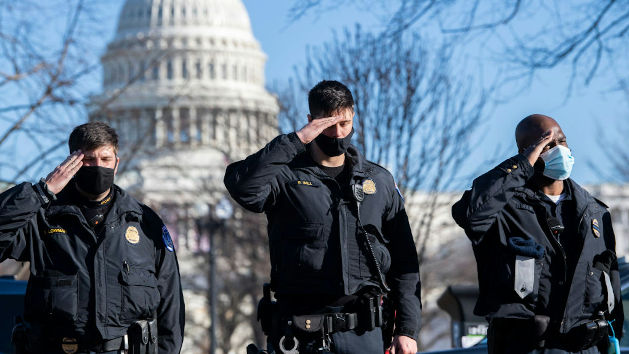 U.S. Capitol Police officers salute as a hearse carrying the body of Officer Brian D. Sicknick, who was killed by rioters Wednesday, passes members of the Capitol and Metropolitan police during a procession on Third Street on Sunday, January 10, 2021.
