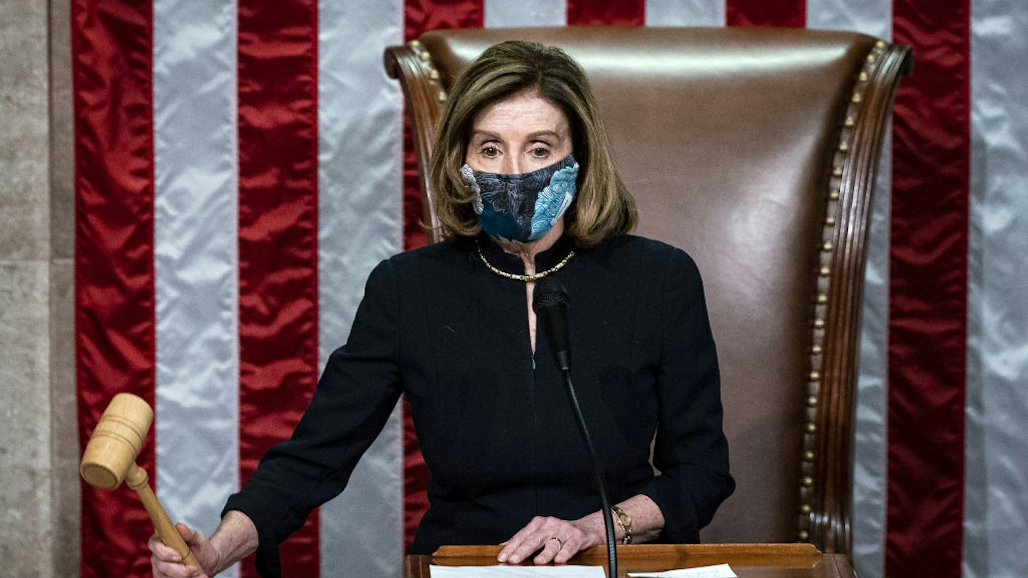 U.S. House Speaker Nancy Pelosi, a Democrat from California, wears a protective mask while banging the Speaker's gavel on the floor of the House at the U.S. Capitol in Washington, D.C., U.S., on Wednesday, Jan. 13, 2021. President Donald Trump was impeached by the U.S. House on a single charge of incitement of insurrection for his role in a deadly riot by his supporters that left five dead and the Capitol ransacked, putting an indelible stain on his legacy with only a week left in his term. Photographer: Al Drago/Bloomberg via Getty Images