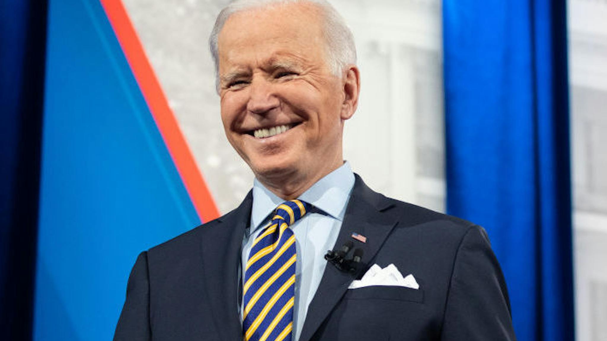 TOPSHOT-US-POLITICS-BIDEN US President Joe Biden holds a face mask as he participates in a CNN town hall at the Pabst Theater in Milwaukee, Wisconsin, February 16, 2021.