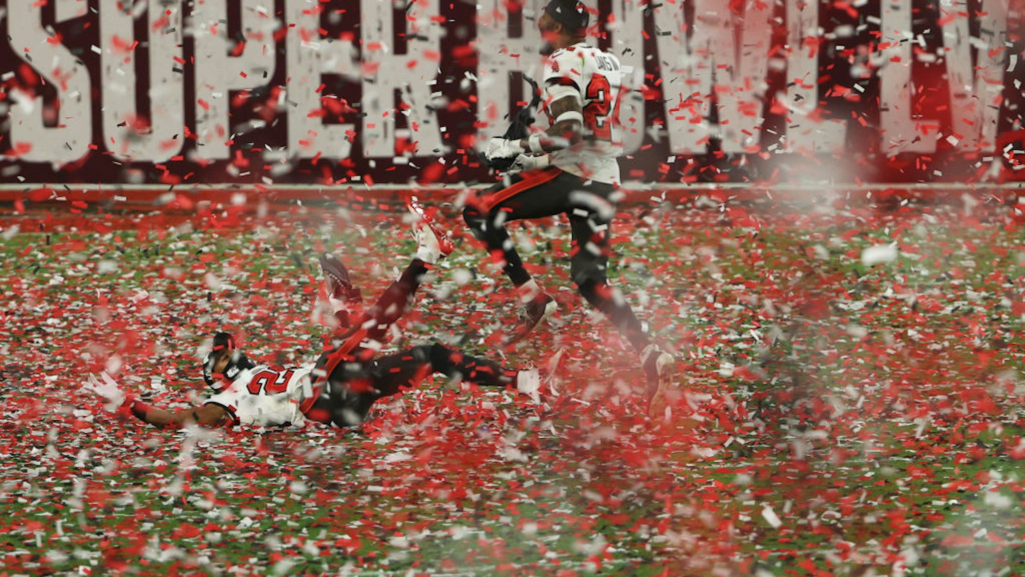 Andrew Adams #26 and Carlton Davis #24 of the Tampa Bay Buccaneers celebrate as confetti falls after defeating the Kansas City Chiefs in Super Bowl LV at Raymond James Stadium on February 07, 2021 in Tampa, Florida.
