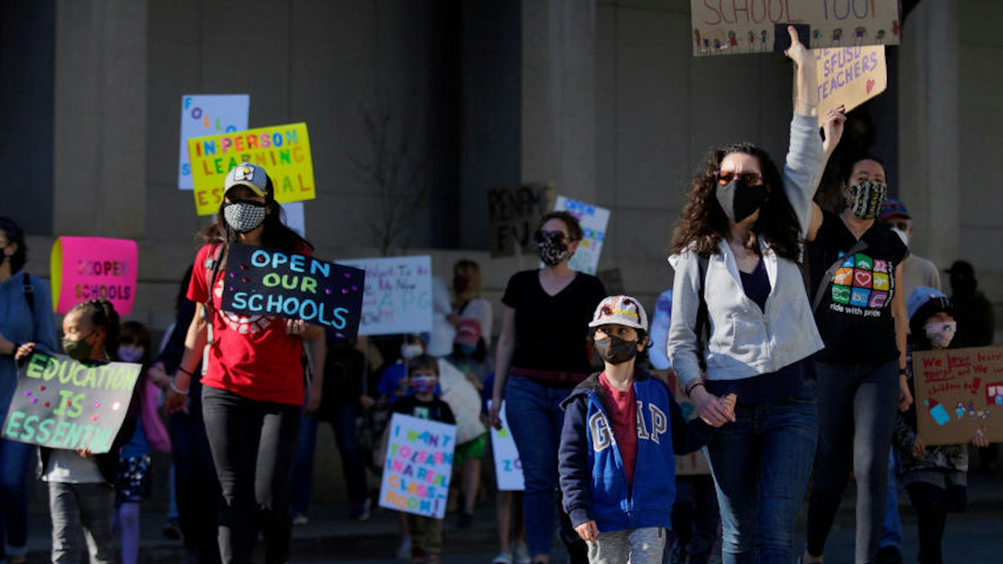 SAN FRANCISCO, CA - FEB. 6: Hundreds of people march to City Hall after rallying outside the SFUSD building, Saturday, Feb. 6, 2021, in San Francisco, Calif. People protested against remote education and demanded schools to reopen in-person education. (Santiago Mejia/The San Francisco Chronicle via Getty Images)