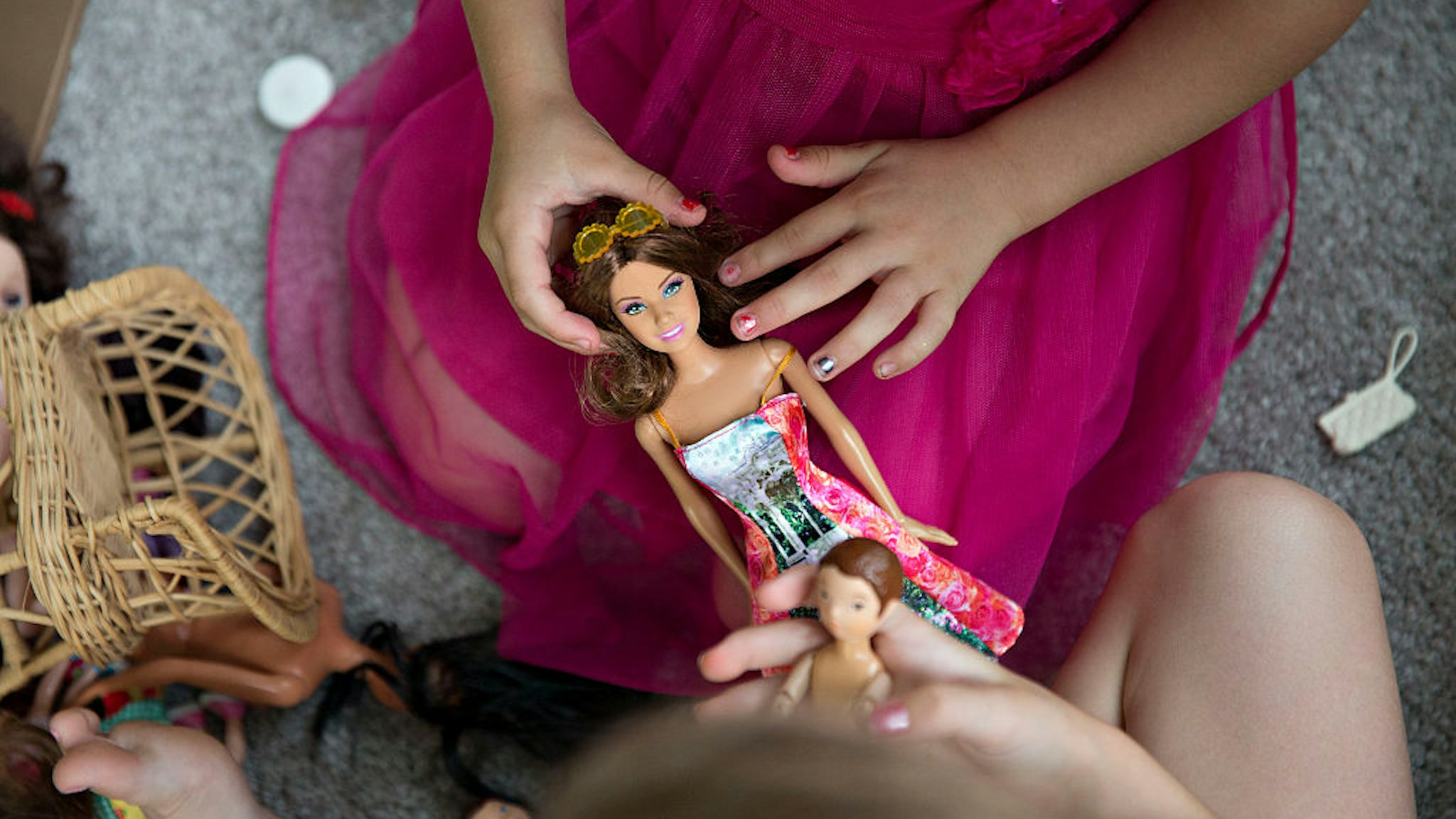 A young girl plays with a Mattel Inc. Barbie doll in Tiskilwa, Illinois, U.S., on Wednesday, July 1, 2015. Mattel Inc. is expected to report quarterly earnings on July 16, 2015. Photographer: Daniel Acker/Bloomberg via Getty Images