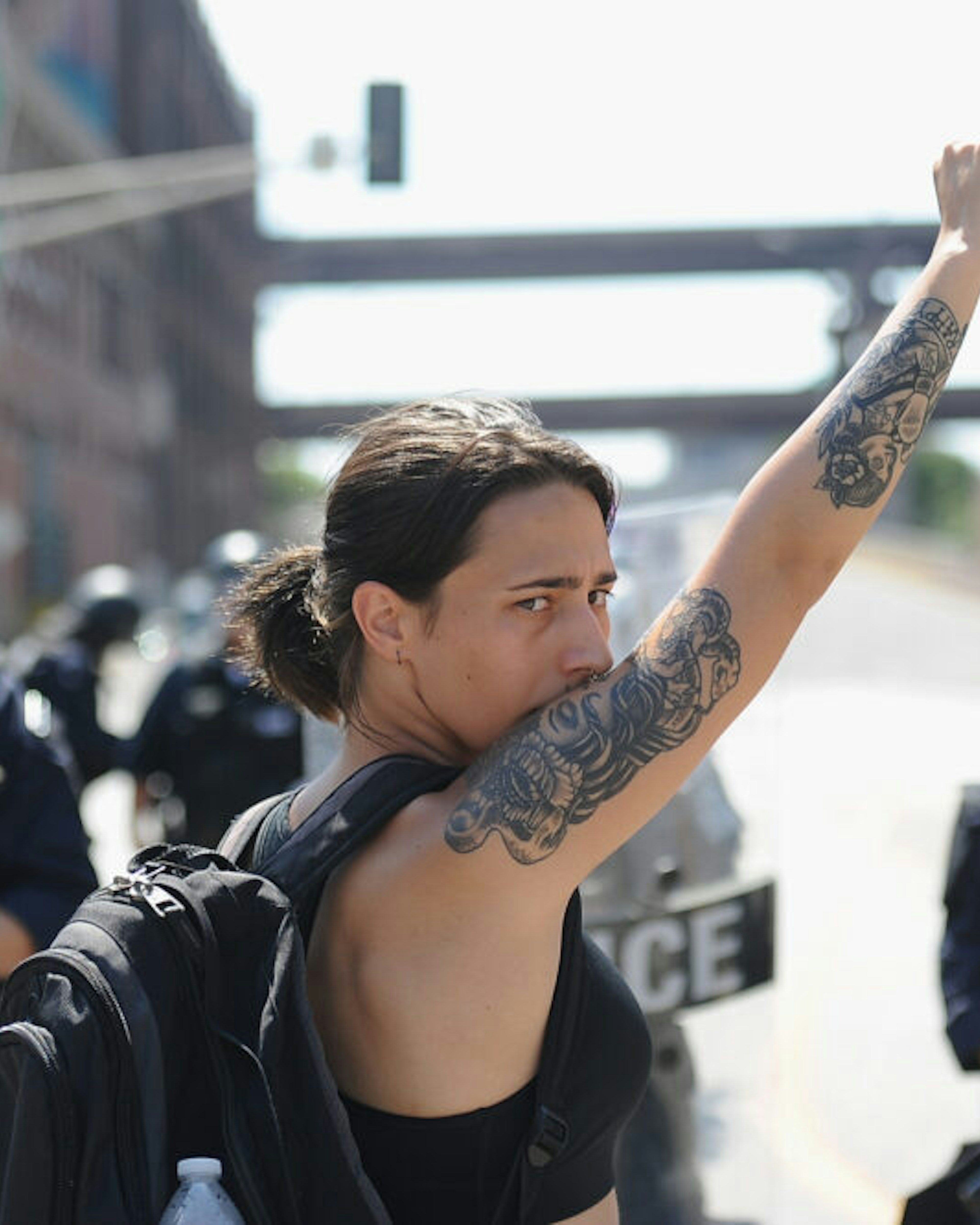 ST. LOUIS, MO - SEPTEMBER 15: A woman raises her fist as she approaches a line of police officers in riot gear during a protest action following a not guilty verdict on September 15, 2017 in St. Louis, Missouri. Protests erupted today following the acquittal of former St. Louis police officer Jason Stockley, who was charged with first-degree murder last year in the shooting death of motorist Anthony Lamar Smith in 2011.