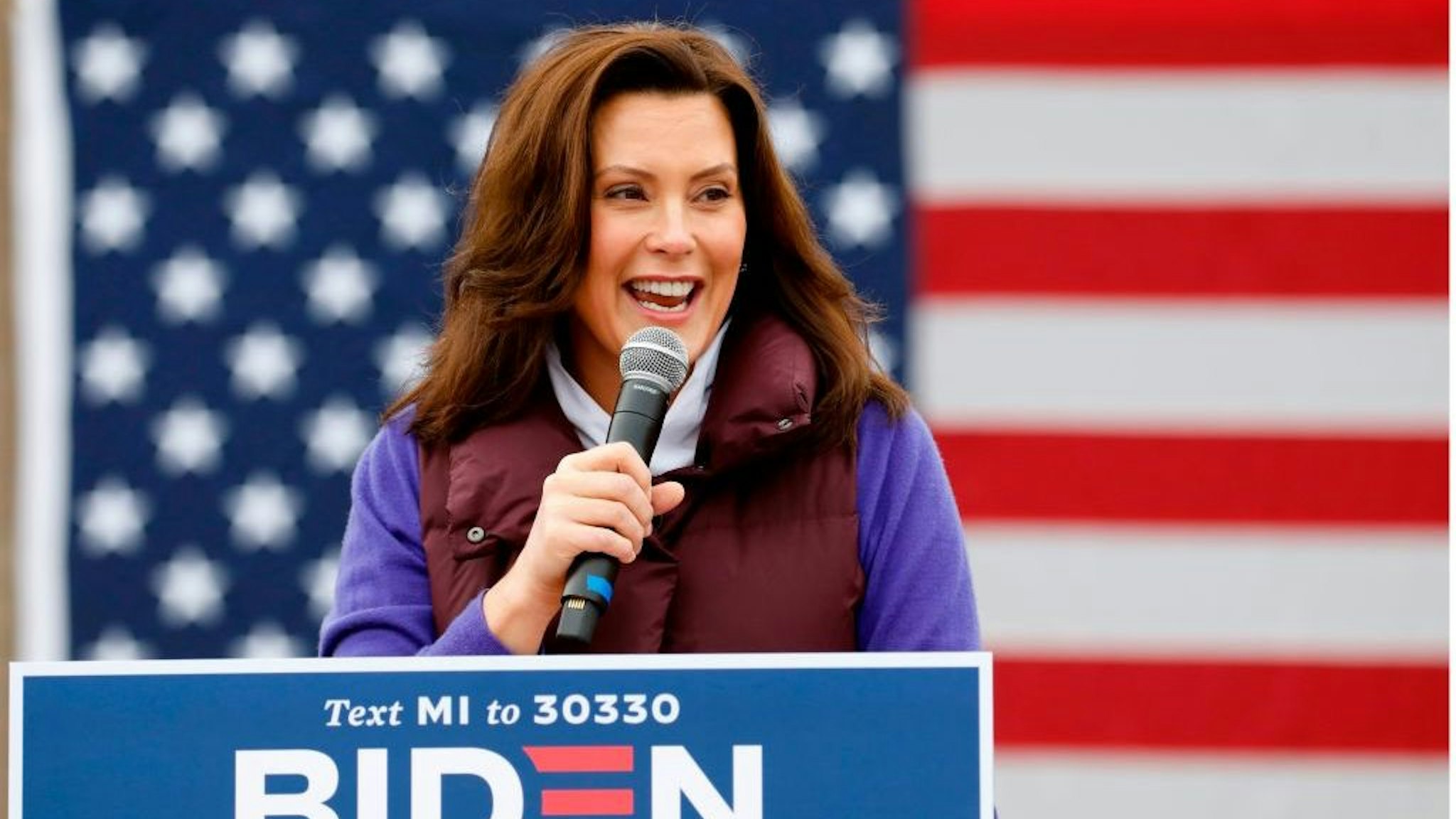 Michigan Governor Gretchen Whitmer talks with people as Democratic vice presidential nominee Senator Kamala Harris (D-CA) takes part in a campaign stop at IBEW Local 58 on October 25, 2020 in Detroit, Michigan. - As she speaks to cheering crowds, drops in to neighborhood coffee shops or pays "surprise" visits to college students, 56-year-old Kamala Harris has brought a jolt of youthful energy to the low-key presidential campaign of her 77-year-old running mate, Democrat Joe Biden. (Photo by JEFF KOWALSKY / AFP) (Photo by JEFF KOWALSKY/AFP via Getty Images)