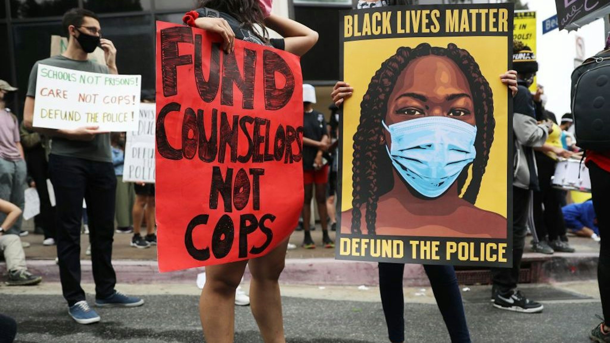 LOS ANGELES, CALIFORNIA - JUNE 23: Black Lives Matter-Los Angeles supporters protest outside the Unified School District headquarters calling on the board of education to defund school police on June 23, 2020 in Los Angeles, California. The demonstrators want the funds currently spent on campus police to be reallocated to other student-serving priorities. (Photo by Mario Tama/Getty Images)