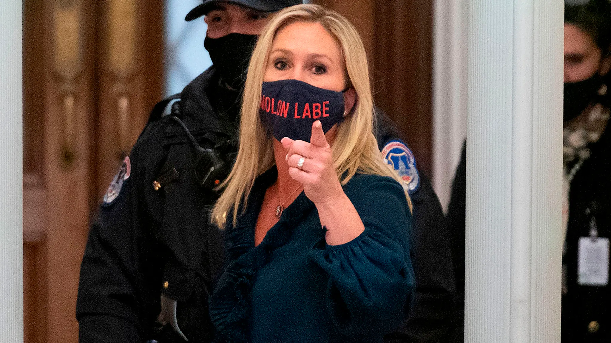 US-POLITICS-CONGRESS-IMPEACHMENT-TRUMP Representative Marjorie Taylor Greene (R-GA) shouts at journalists as she goes through security outside the House Chamber at Capitol Hill in Washington, DC on January 12, 2021. - On the eve of his likely impeachment, President Donald Trump on Tuesday denied responsibility for the storming of Congress by a mob of his supporters, and warned of "tremendous anger" across the country.