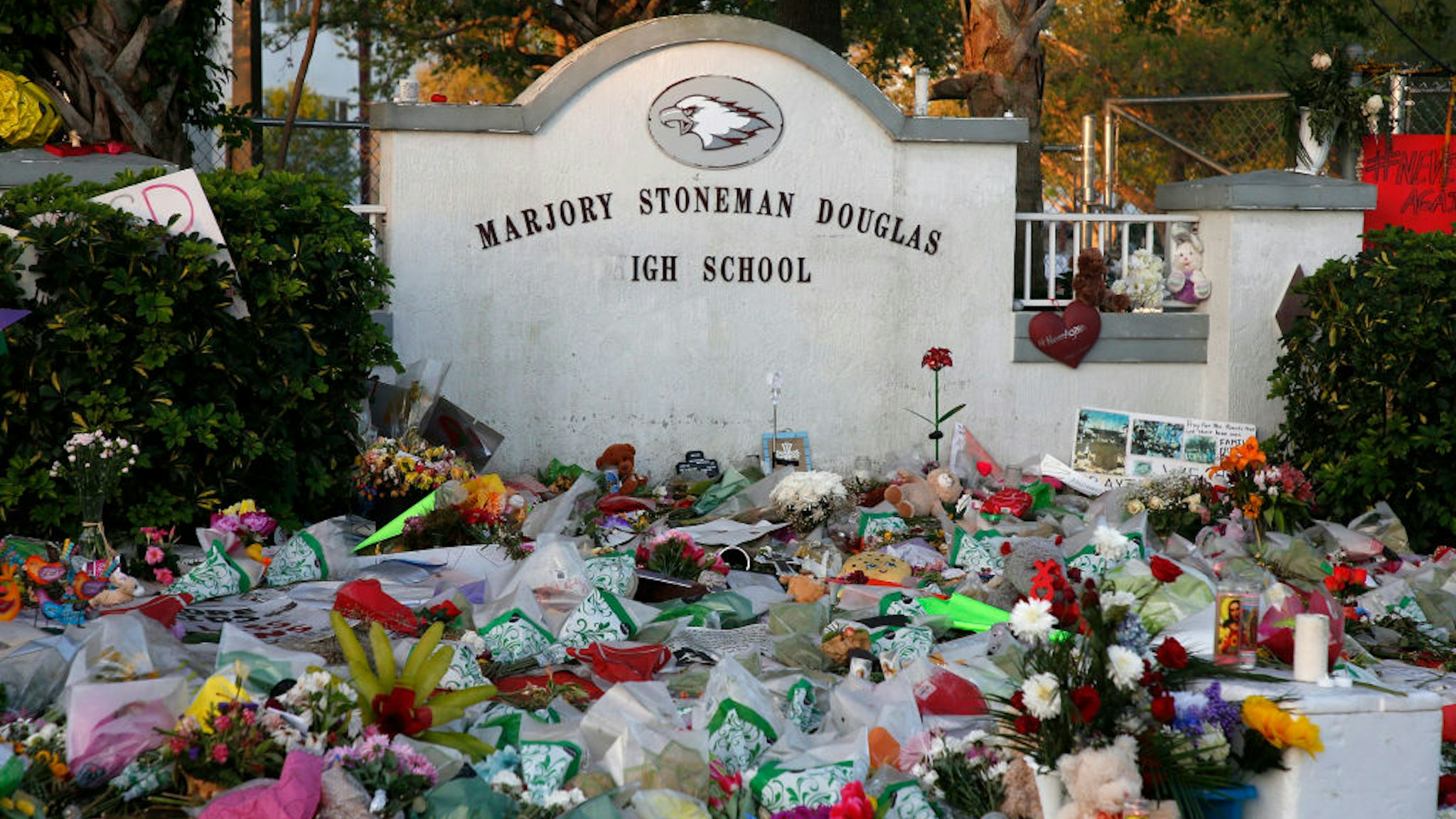 Flowers, candles and mementos sit outside one of the makeshift memorials at Marjory Stoneman Douglas High School in Parkland, Florida on February 27, 2018. Florida's Marjory Stoneman Douglas high school will reopen on February 28, 2018 two weeks after 17 people were killed in a shooting by former student, Nikolas Cruz, leaving 17 people dead and 15 injured on February 14, 2018.