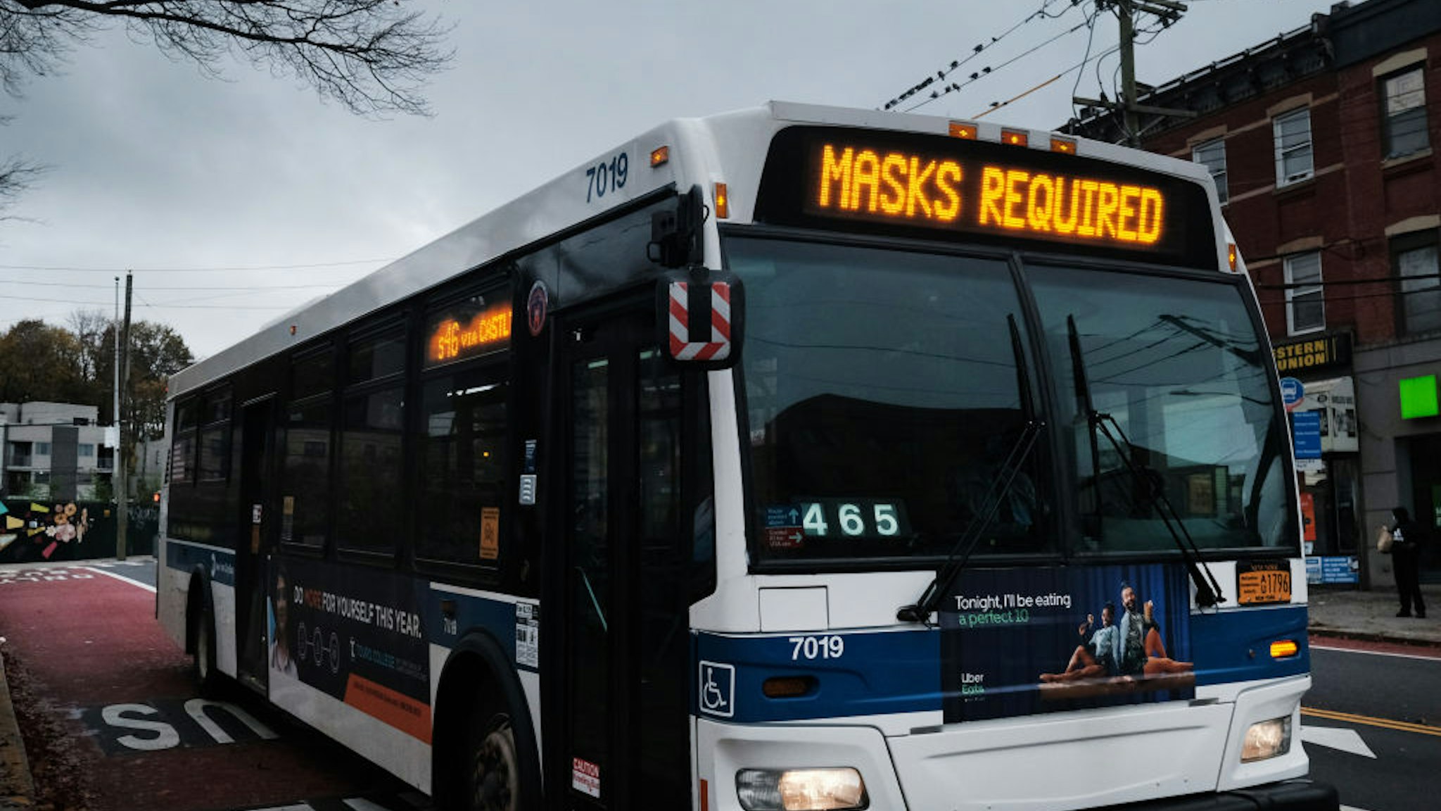 NEW YORK, NEW YORK - NOVEMBER 12: A bus displays a message noting masks are required to board on November 12, 2020 in the in Staten Island borough of New York City. Staten Island's seven-day positive test rate for Covid-19 is the highest in the city. Two Staten Island ZIP codes have now risen above the five percent infection rate, prompting Gov. Andrew Cuomo to declare the borough a "yellow zone," which includes limits on outdoor gatherings to 25 people and attendance at churches to 50 percent capacity.