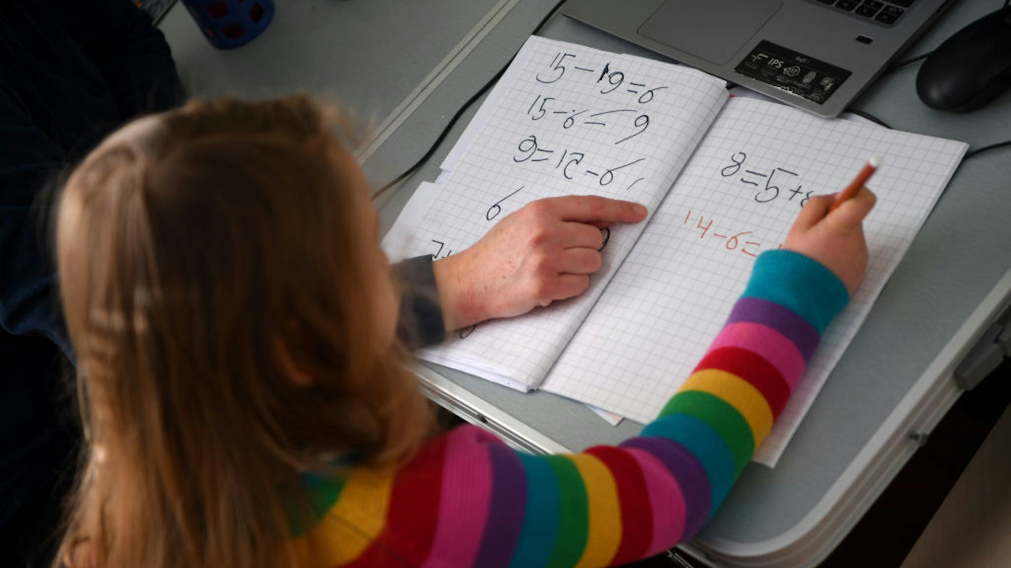 Five-year-old Lois Copley-Jones, who is the photographer's daughter, does her Maths studies in her bedroom on January 25, 2021 in Newcastle-under-Lyme, England. Under current government policy, schools in England wouldn't open before the February half-term break at the earliest, but the Prime Minister has declined to commit to reopening them before Easter.
