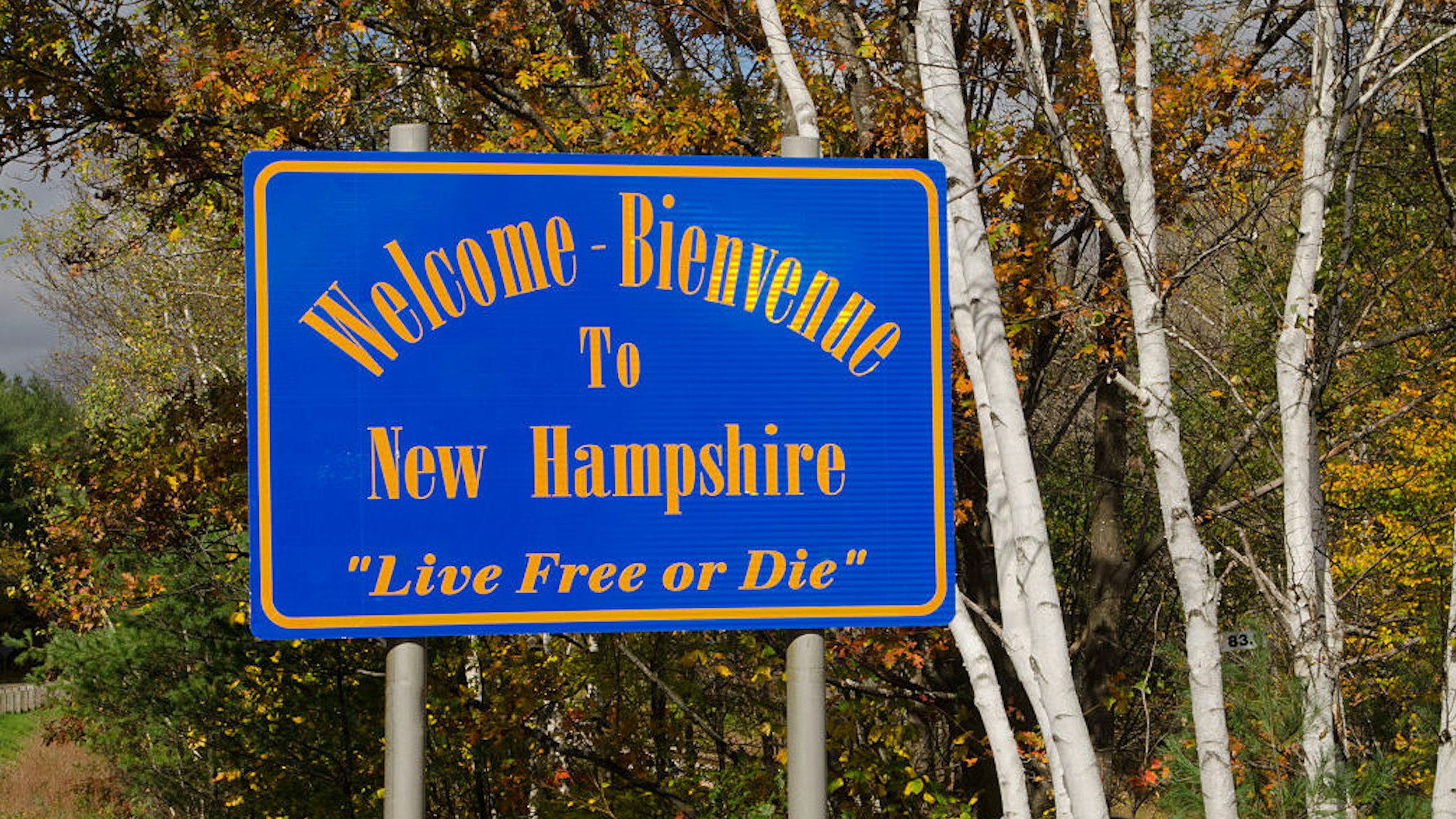 Welcome to New Hampshire sign in Northern New England in fall foliage