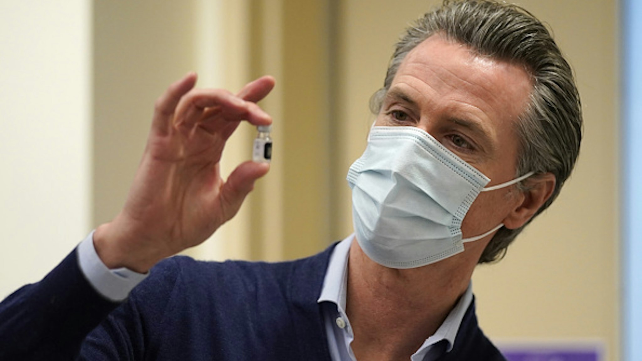 Gavin Newsom, governor of California, holds a vial of the Pfizer-BioNTech Covid-19 vaccine at Kaiser Permanente Los Angeles Medical Center in Los Angeles, California, U.S., on Monday, Dec. 14, 2020. The first Covid-19 vaccine shots were administered by U.S. hospitals Monday, the initial step in a historic drive to immunize millions of people as deaths approach the 300,000 mark.