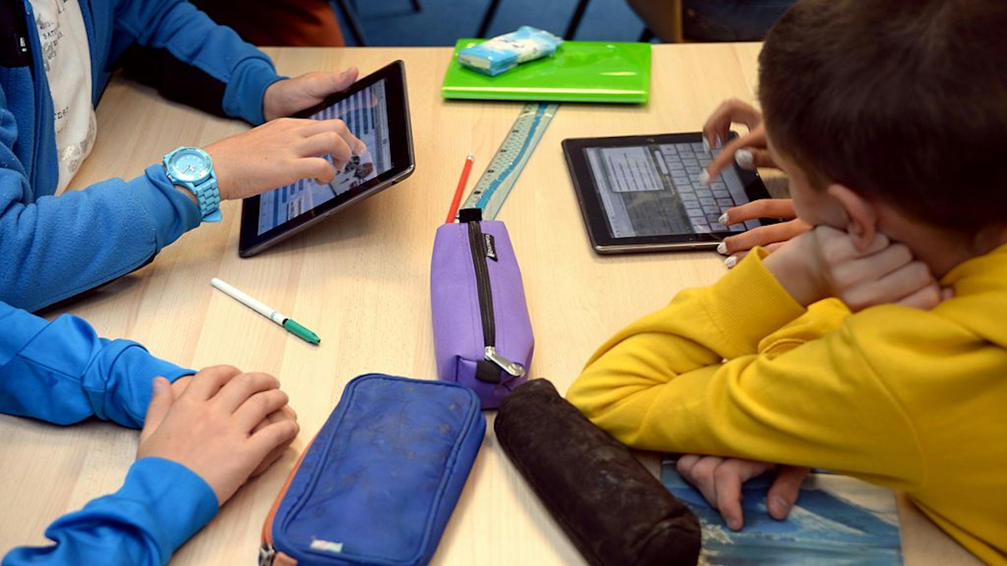 Pupils use tablets during courses in a classroom at the Leonard de Vinci 'connected' middle school in Saint-Brieuc, western France on September 12, 2013. The Leonard de Vinci school is one of the 23 middle schools in France to be connected to the internet and to be using new information technologies during courses. AFP