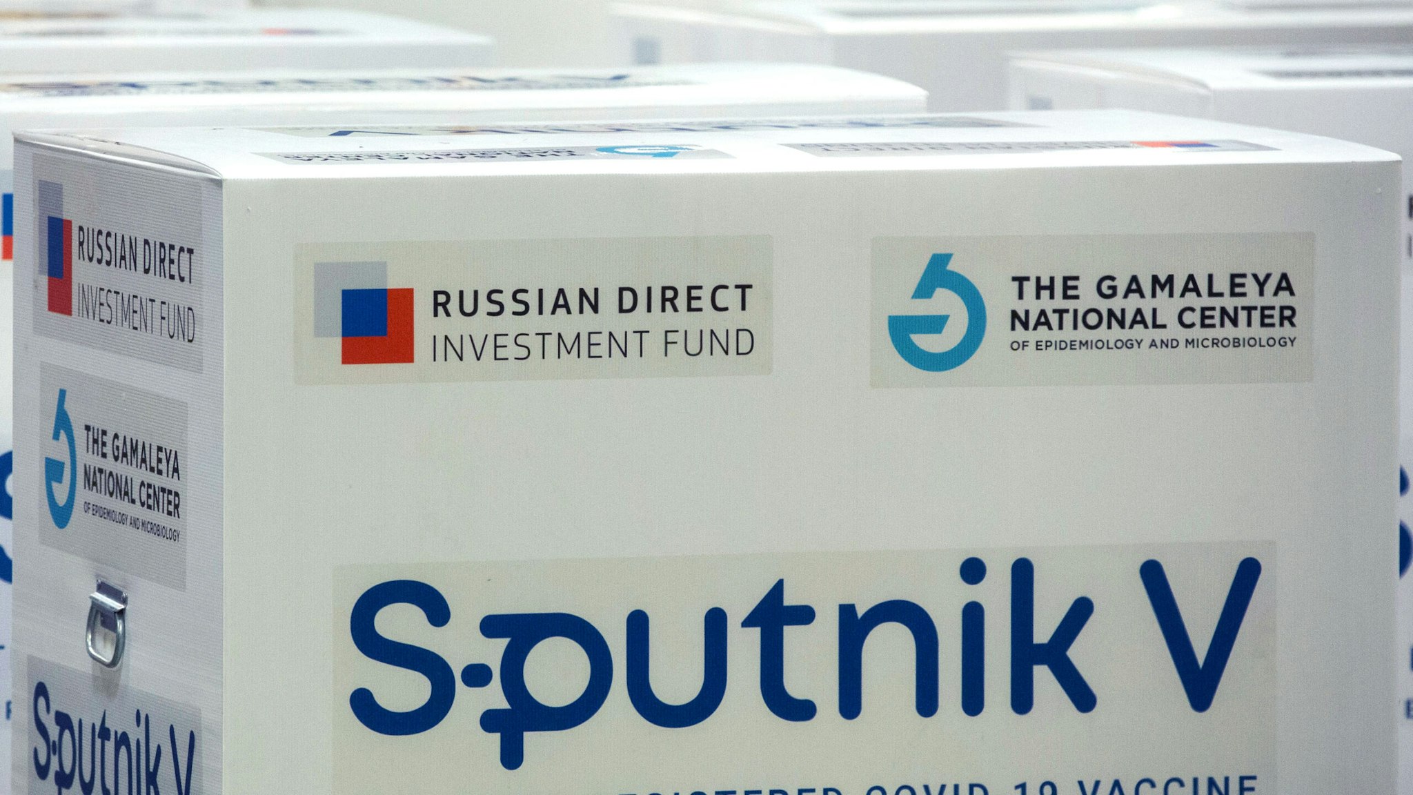 Branding reading 'The first registered Covid-19 vaccine' on boxes of the Sputnik V COVID-19 vaccine, developed by the Gamaleya National Research Center for Epidemiology and Microbiology and the Russian Direct Investment Fund (RDIF), at the cargo terminal at Sheremetyevo International Airport OAO in Moscow, Russia, on Thursday, Feb. 11, 2021. Montenegro and St. Vincent and the Grenadines approved Russian-developed vaccine for use, bringing total number of countries that have authorized it to 26, Russian Direct Investment Fund says in statement.