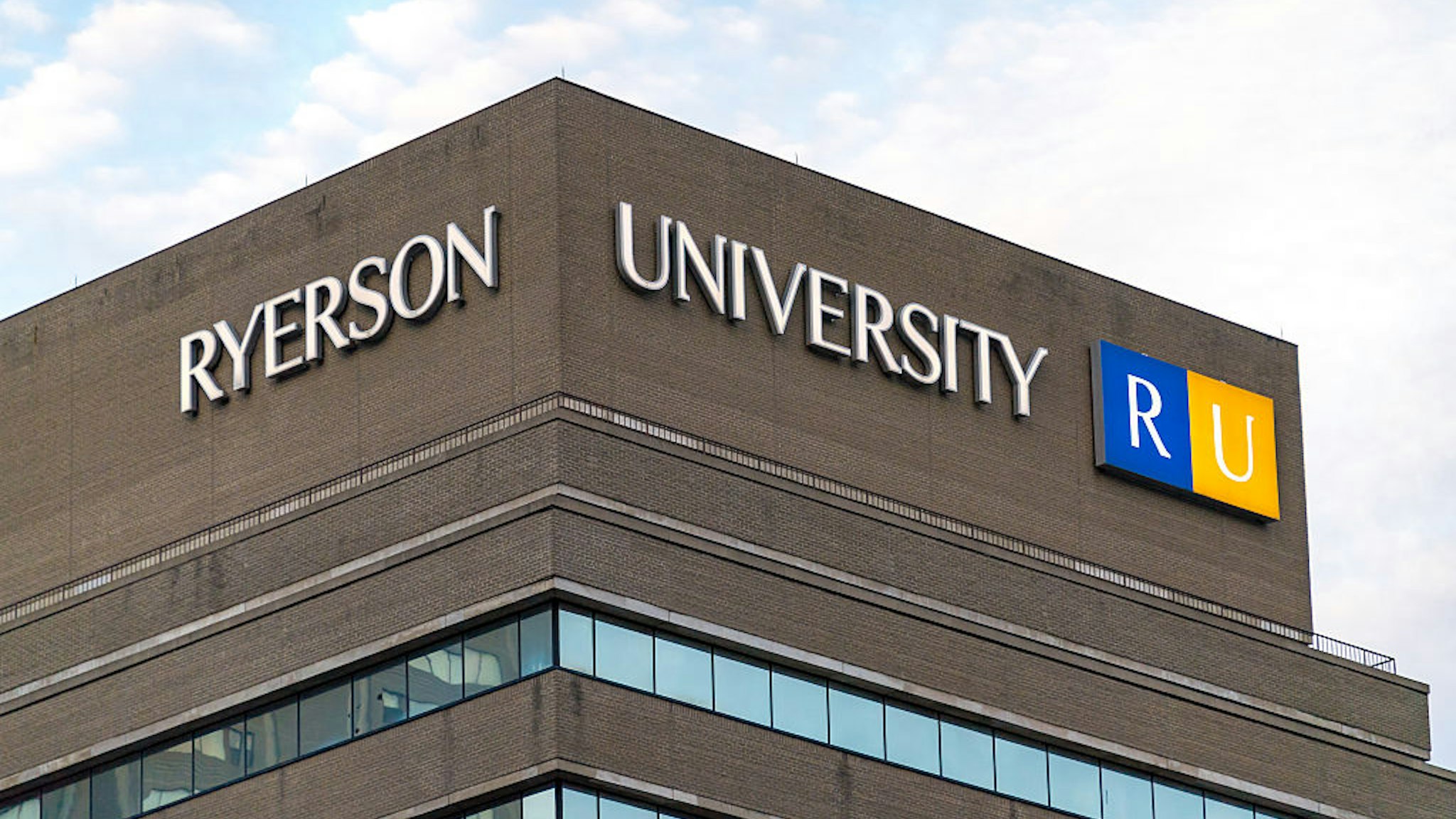Ryerson University modern building facade exterior: School's logo at the top of the building.