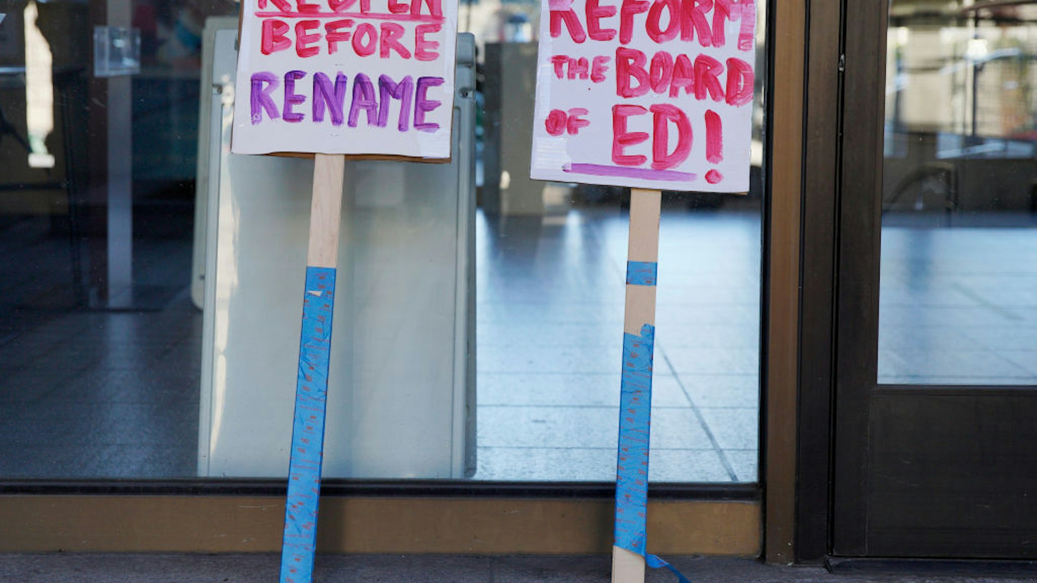 SAN FRANCISCO, CA - FEB. 6: Protesters leave their signs outside the SFUSD building after a rally and march, Saturday, Feb. 6, 2021, in San Francisco, Calif. People protested against remote education and demanded schools to reopen in-person education.