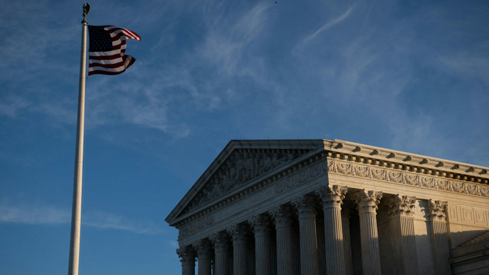 An American flag flies outside of the U.S. Supreme Court in Washington, D.C., U.S., on Saturday, Jan. 9, 2021. House Democrats are prepared to impeach President Donald Trump if he doesn't immediately resign, House Speaker Nancy Pelosi said, as the president came under increasing pressure from members of both parties for encouraging a mob that stormed the U.S. Capitol