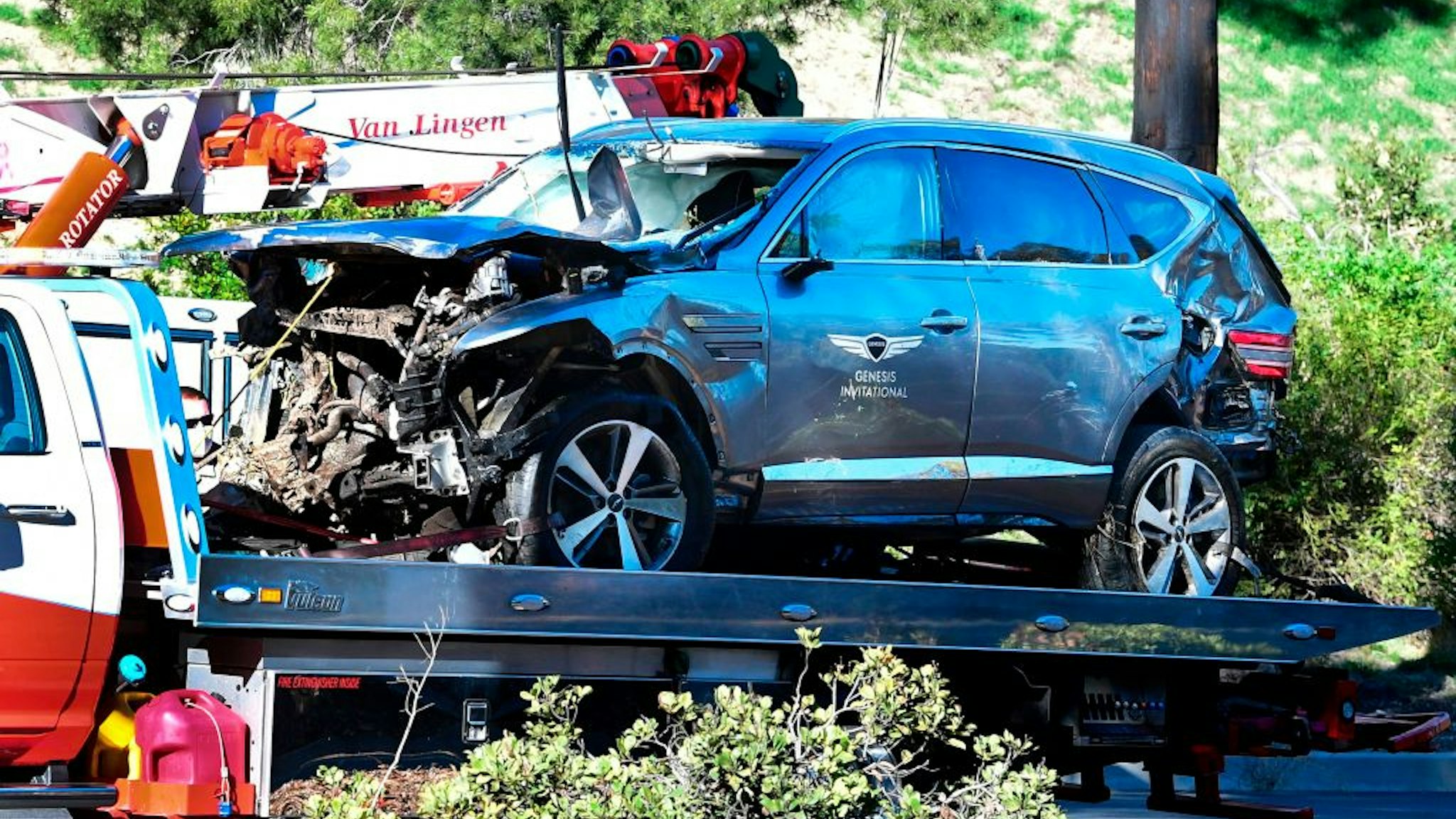 A tow truck recovers the vehicle driven by golfer Tiger Woods in Rancho Palos Verdes, California, on February 23, 2021, after a rollover accident. - Woods was hospitalized Tuesday after a car crash in which his vehicle sustained "major damage," the Los Angeles County Sheriff's department said. Woods, the sole occupant, was removed from the wreckage by firefighters and paramedics, and suffered "multiple leg injuries," his agent said in a statement to US media.