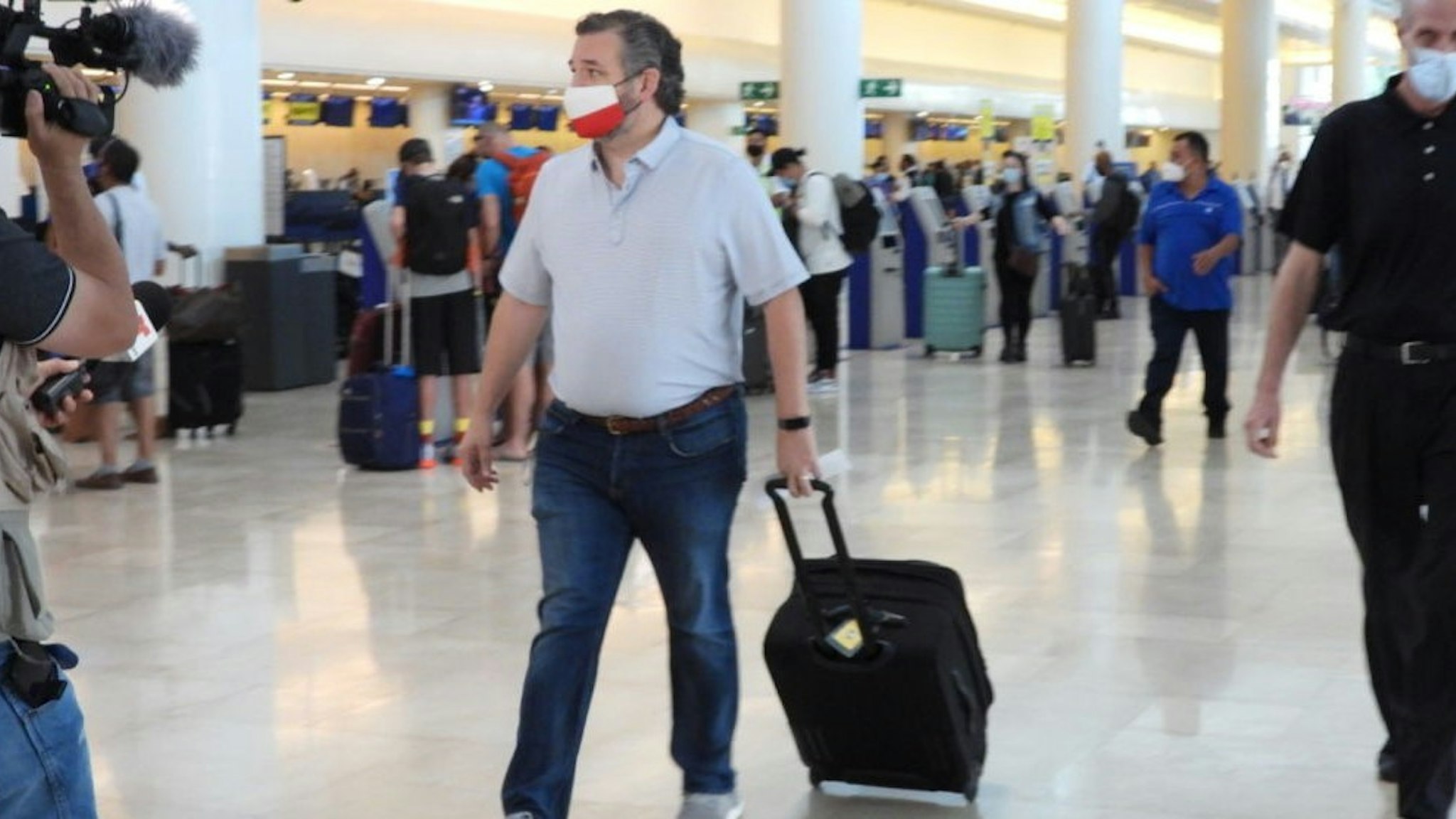 CANCUN, MEXICO - FEBRUARY 18: Sen. Ted Cruz (R-TX) checks in for a flight at Cancun International Airport after a backlash over his Mexican family vacation as his home state of Texas endured a Winter storm on February 18, 2021 in Cancun, Quintana Roo, Mexico. The Republican politician came under fire after leaving for the warm holiday destination as hundreds of thousands of people in the lone star state suffered a loss of power. Reports stated that Cruz was due to catch a flight back to Ho