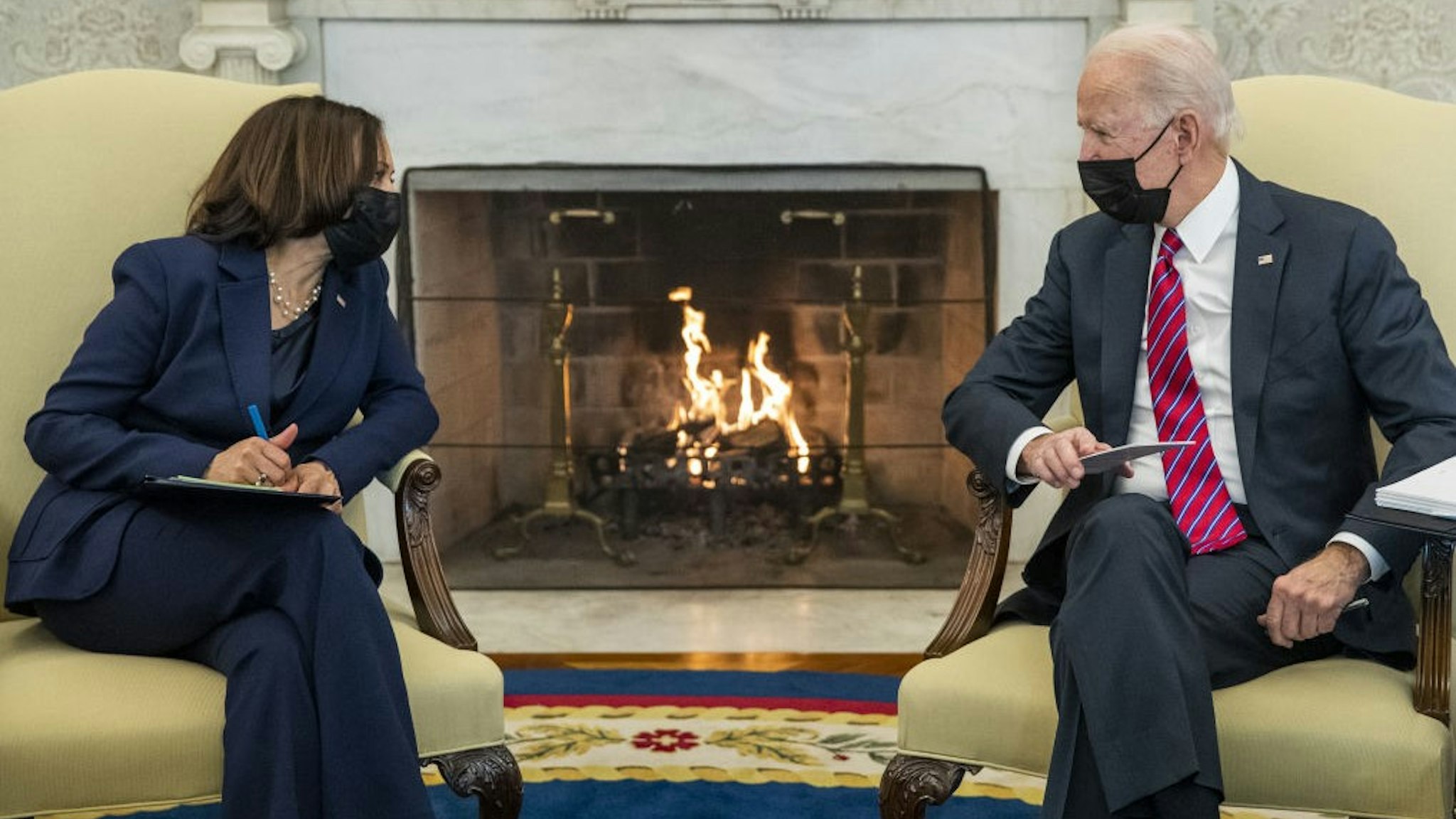 U.S. President Joe Biden speaks with U.S. Vice President Kamala Harris during a meeting with Janet Yellen, U.S. Treasury secretary, not pictured, in the Oval Office of the White House in Washington, D.C., U.S., on Friday, Jan. 29, 2021. Yellen said she'll try to "better understand" the financial risks of taking steps to combat climate change, while expressing support for Biden's decision to cancel the Keystone XL Pipeline.Photographer: