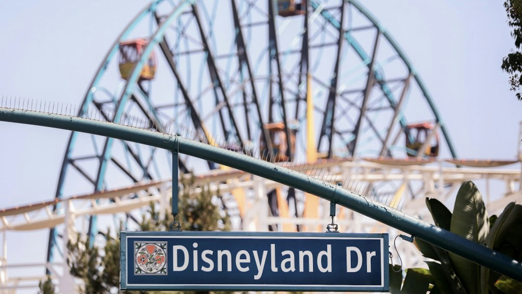 ANAHEIM, CALIFORNIA - SEPTEMBER 30: A sign for Disneyland Drive hangs near empty amusement rides on September 30, 2020 in Anaheim, California. Disney is laying off 28,000 workers amid the toll of the COVID-19 pandemic on theme parks. (Photo by Mario Tama/Getty Images)