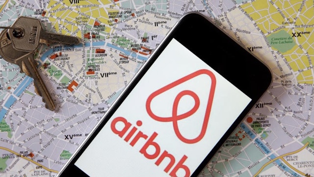 PARIS, FRANCE - FEBRUARY 11: In this photo illustration, the Airbnb logo is displayed on the screen of an iPhone placed on a map of the city of Paris on February 11, 2019 in Paris, France. Paris is one of the most popular destinations for Airbnb, but city authorities do not agree with the private rental and booking company. The mayor of Paris, Anne Hidalgo, announced Sunday that the city would sue Airbnb for 14 million dollars, because of the alleged list of 1,000 illegal rentals. (Photo by Chesnot/Getty Images)