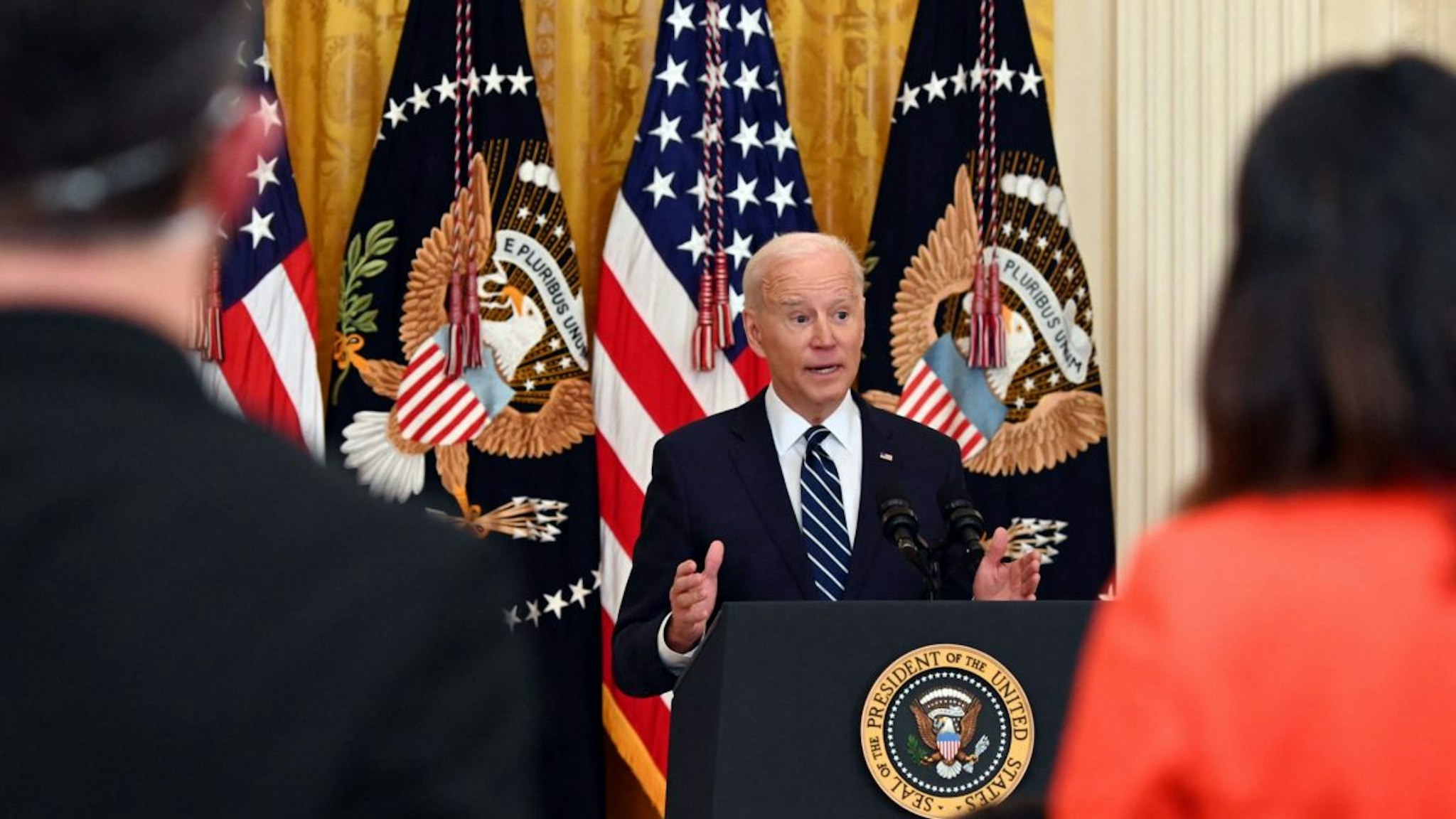 US President Joe Biden answers a question during his first press briefing in the East Room of the White House in Washington, DC, on March 25, 2021.