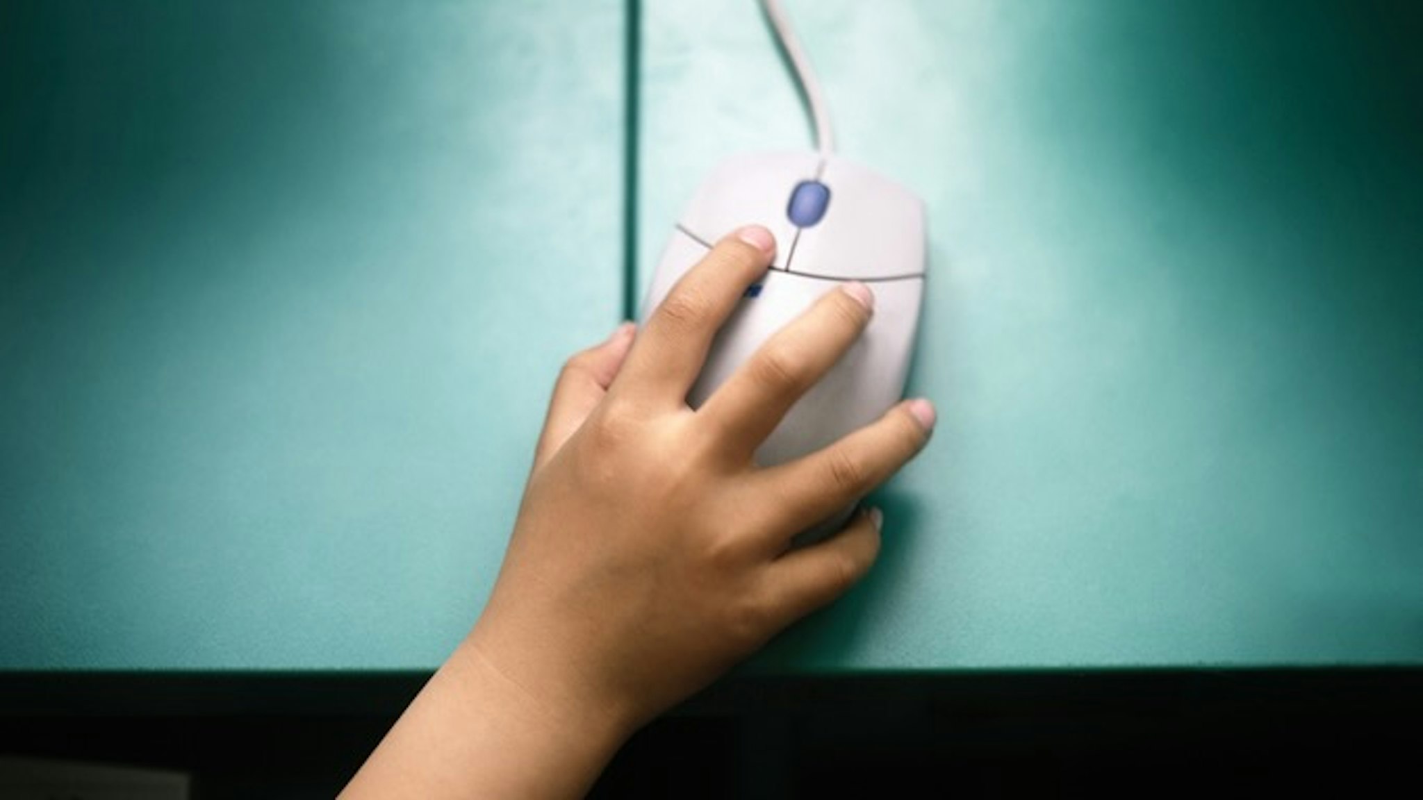 Child's Hand on Computer Mouse - stock photo