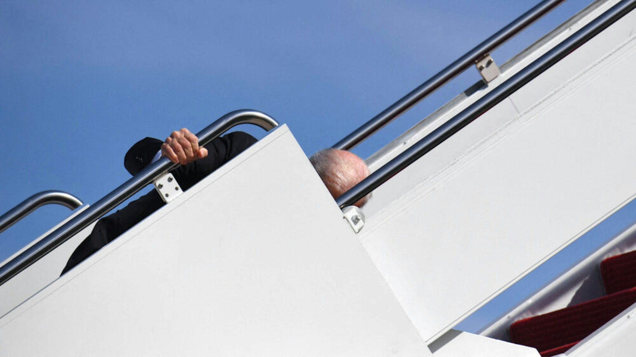 TOPSHOT - US President Joe Biden trips as he boards Air Force One at Joint Base Andrews in Maryland on March 18, 2021. - President Biden travels to Atlanta, Georgia, to tour the Centers for Disease Control and Prevention, and to meet with Georgia Asian American leaders, following the Atlanta Spa shootings.