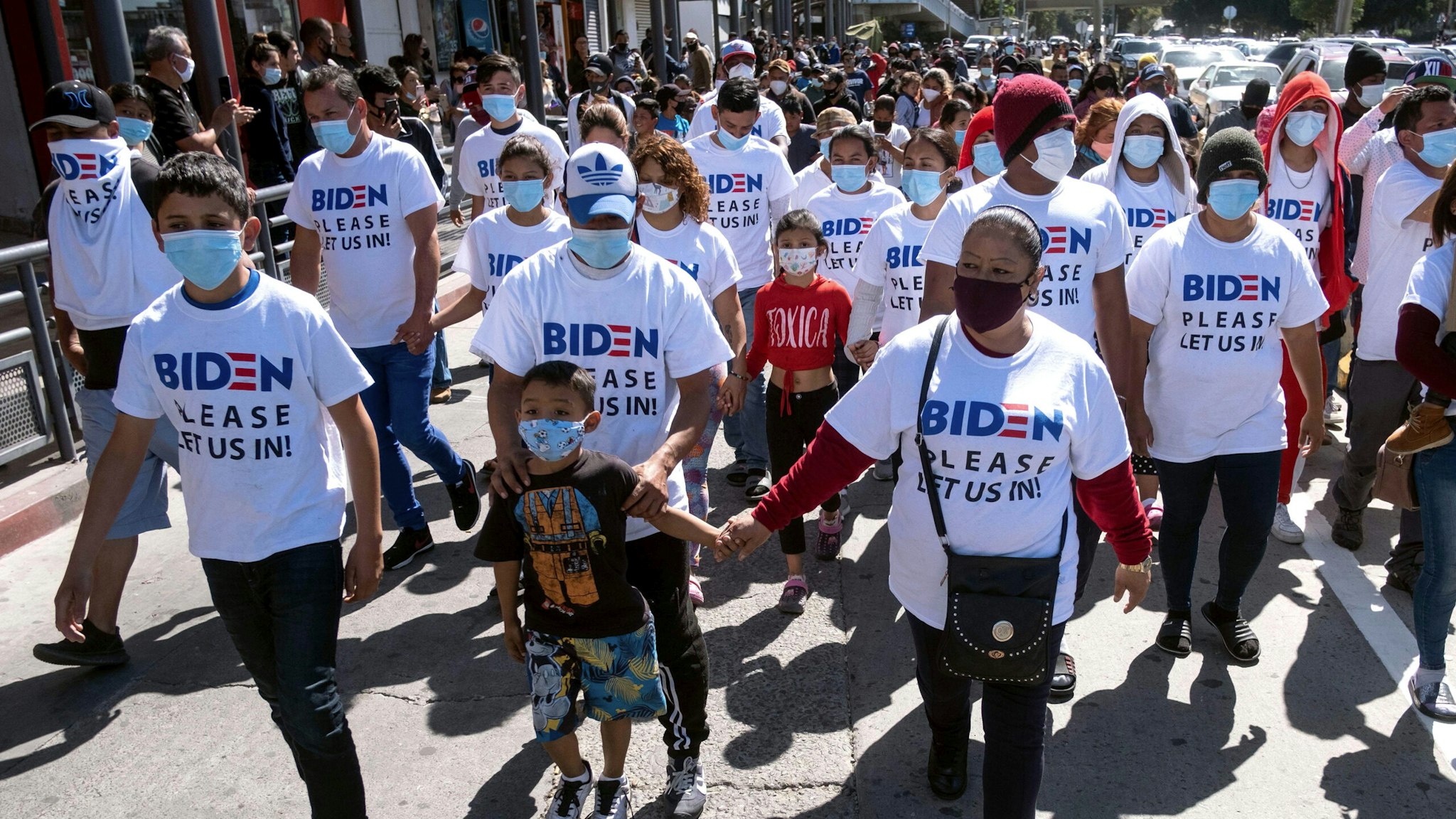 Migrants hold a demonstration demanding clearer United States migration policies, at San Ysidro crossing port in Tijuana, Baja California state, Mexico on March 2, 2021. - Thousands of migrants out of the Migrant Protection Protocol (MPP) program are stranded along the US-Mexico border without knowing when or how they will be able to start their migratory process with US authorities.