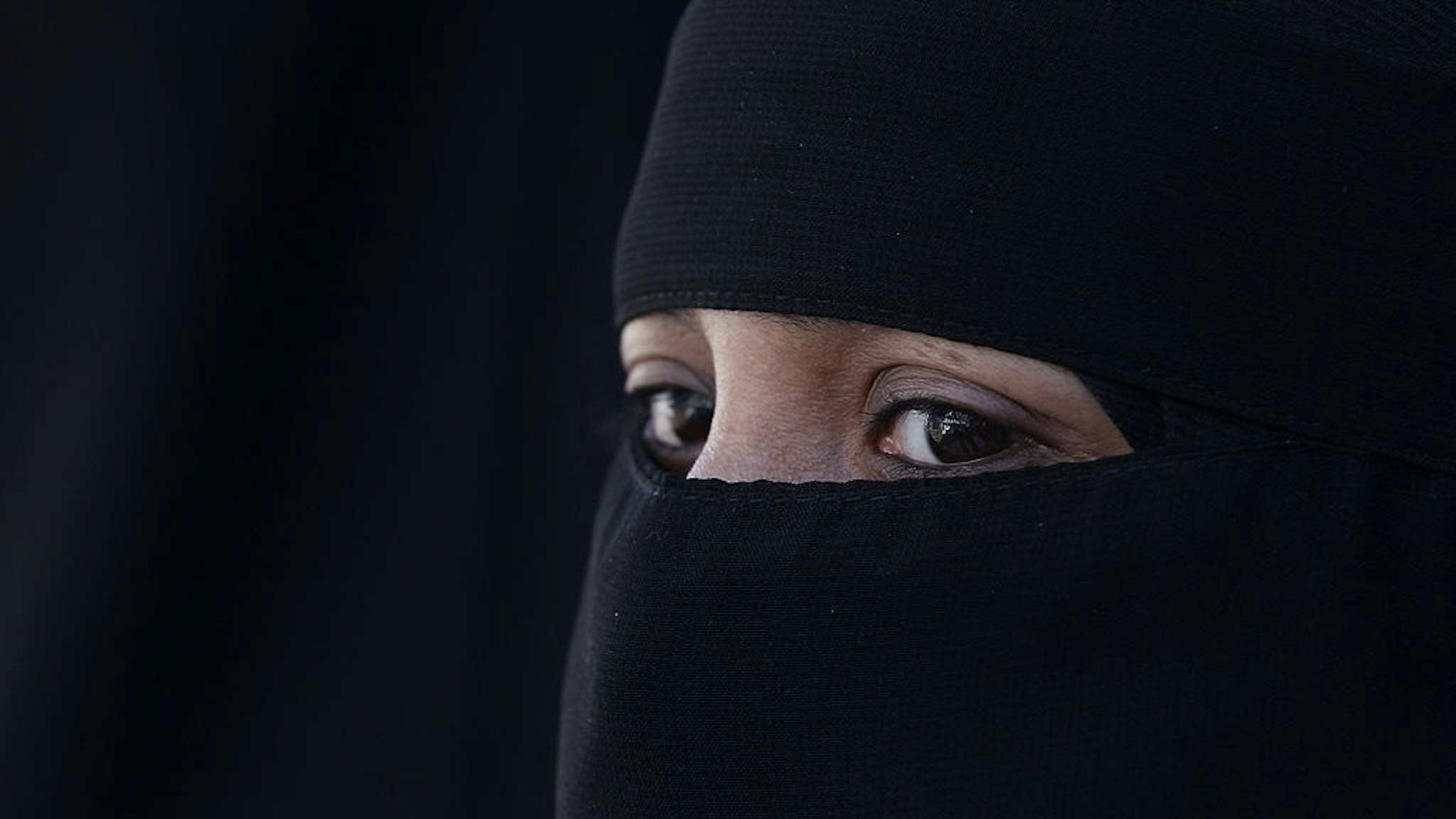 LONDON, ENGLAND - APRIL 11: A woman wears an Islamic niqab veil stands outside the French Embassy during a demonstration on April 11, 2011 in London, England. France has become the first country in Europe to ban the wearing of the veil and in Paris two women have been detained by police under the new law. (Photo by Peter Macdiarmid/Getty Images)