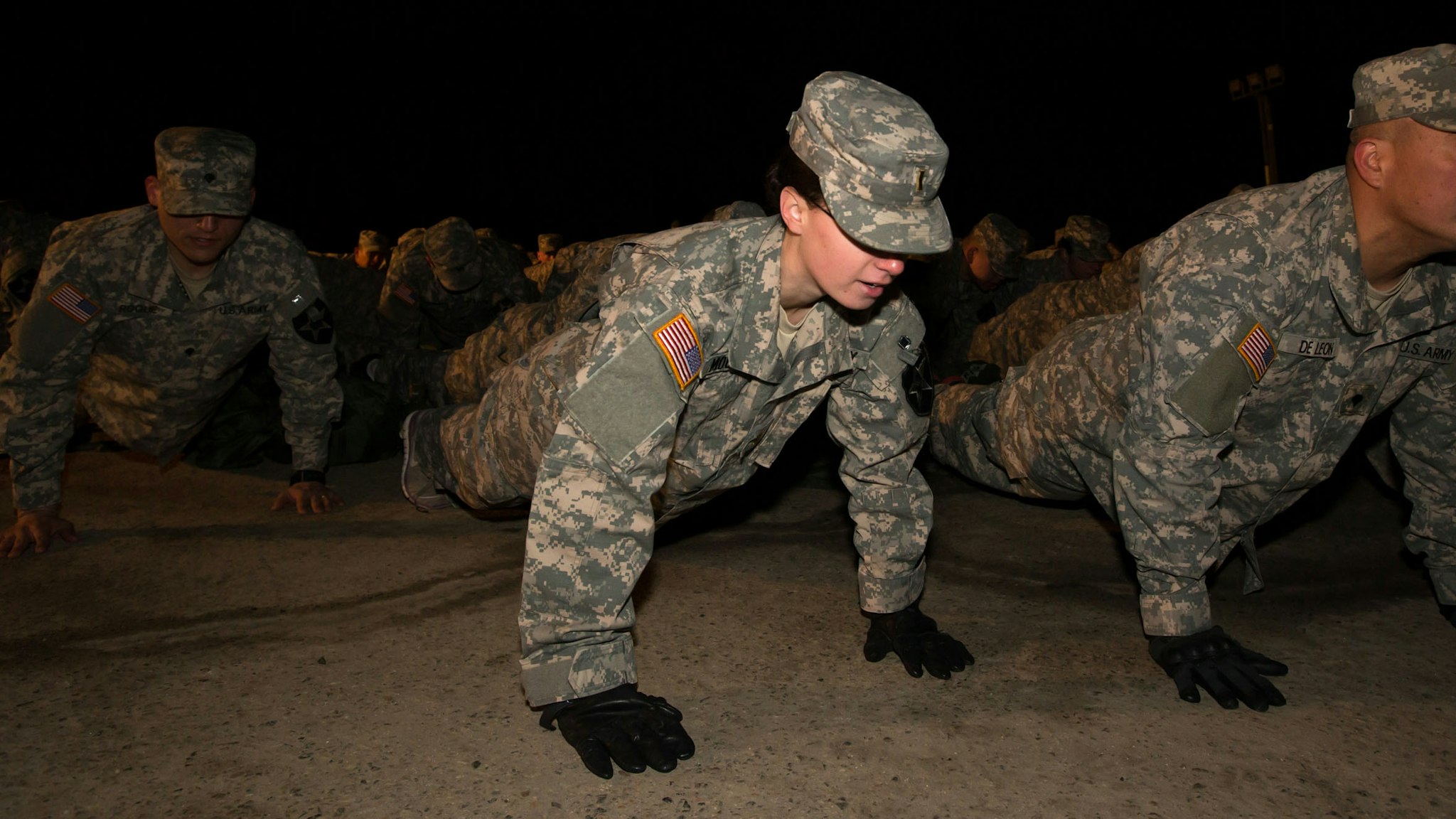 Soldiers with the U.S. Army's Second Infantry Division do push-ups during an air assault training course before dawn at Camp Casey in Dongducheon, South Korea, on Tuesday, Feb. 26, 2013. The U.S. has 28,500 soldiers in South Korea as a legacy of the 1950-53 Korean War, which ended in a cease-fire that left the two Koreas technically still at war.