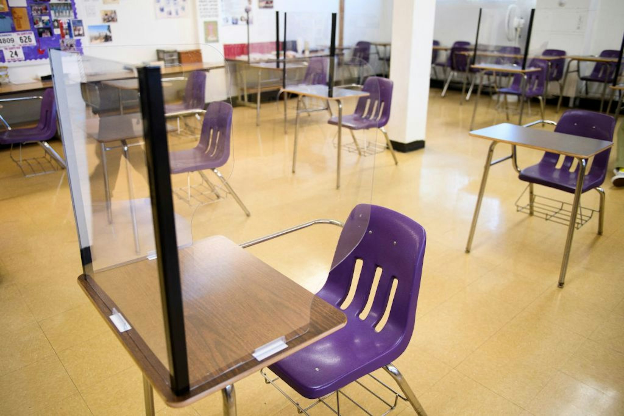 Plexiglass dividers surround desks as students return to in-person learning at St. Anthony Catholic High School during the Covid-19 pandemic on March 24, 2021 in Long Beach, California. - The school of 445 students implemented a hybrid learning model, with approximately 60 percent of students returning to in an in-person classroom learning environment with Covid-19 safety measures including face masks, social distancing, plexiglass barriers around desks, outdoor spaces, and schedule changes.