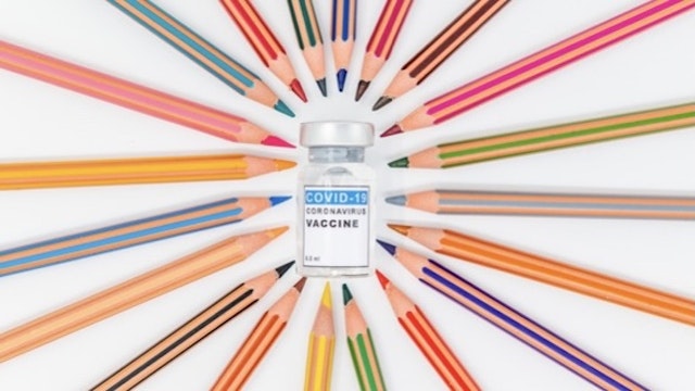 Colorful pencils in circle and Covid19 vaccine - stock photo Colorful pencils on white table pointing to a vaccine. End of the pandemic crisis due to vaccination