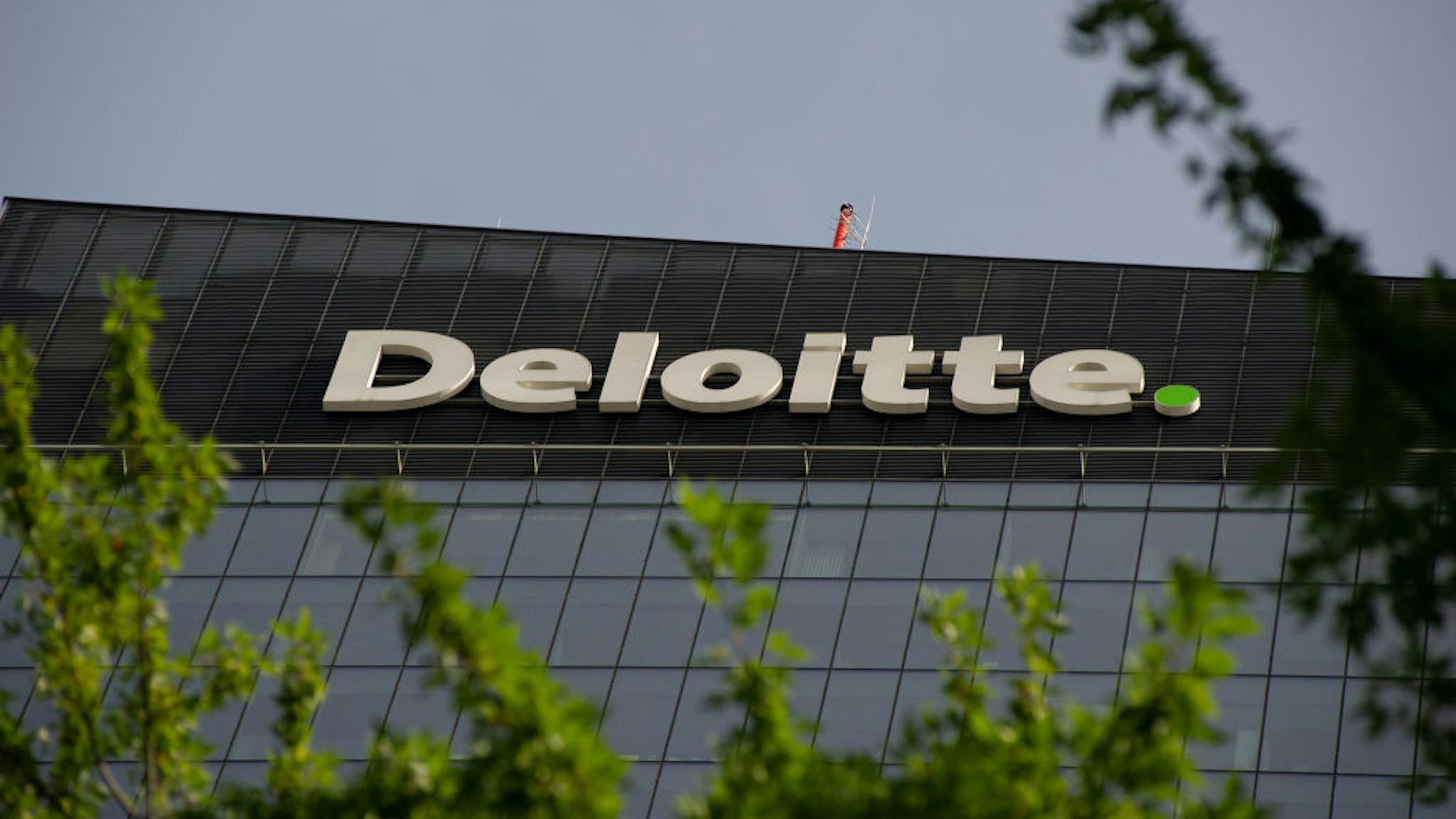 Multinational professional services network company Deloitte sign is seen on top of the Q22 offices complex on September 19, 2020 in Warsaw, Poland.