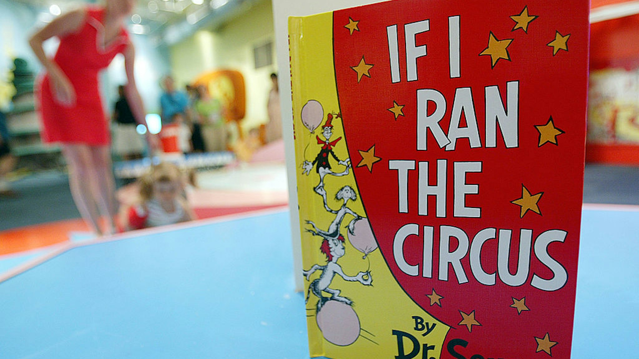 NEW YORK - JULY 6: A Dr. Seuss book is seen as children play during a press preview of an interactive exhibition dedicated to Dr. Seuss at the Children's Museum of Manhattan July 6, 2004 in New York City. The 4,000 square-foot exhibit is titled, 'Oh Suess! Off to Great Places' and will remain open at the museum until July 2005.