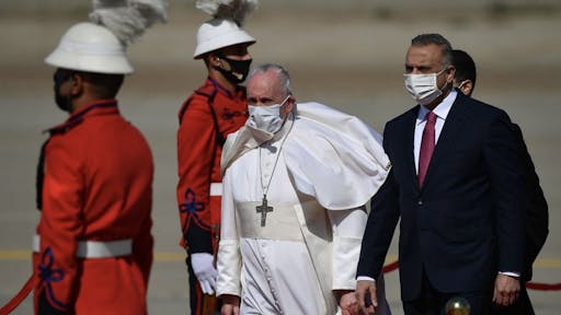 FB1B25F1-F68F-4D2F-9B53-CA4DB3A4F6DB_1_201_a TOPSHOT - Pope Francis walks alongside Iraq's Prime Minister Mustafa al-Kadhem upon his arrival in Baghdad on March 5, 2021 on the first papal visit to Iraq. - Pope Francis began his historic trip to war-scarred Iraq, defying security concerns and the coronavirus pandemic to comfort one of the world's oldest and most persecuted Christian communities. (Photo by Vincenzo PINTO / AFP) (Photo by VINCENZO PINTO/AFP via Getty Images)