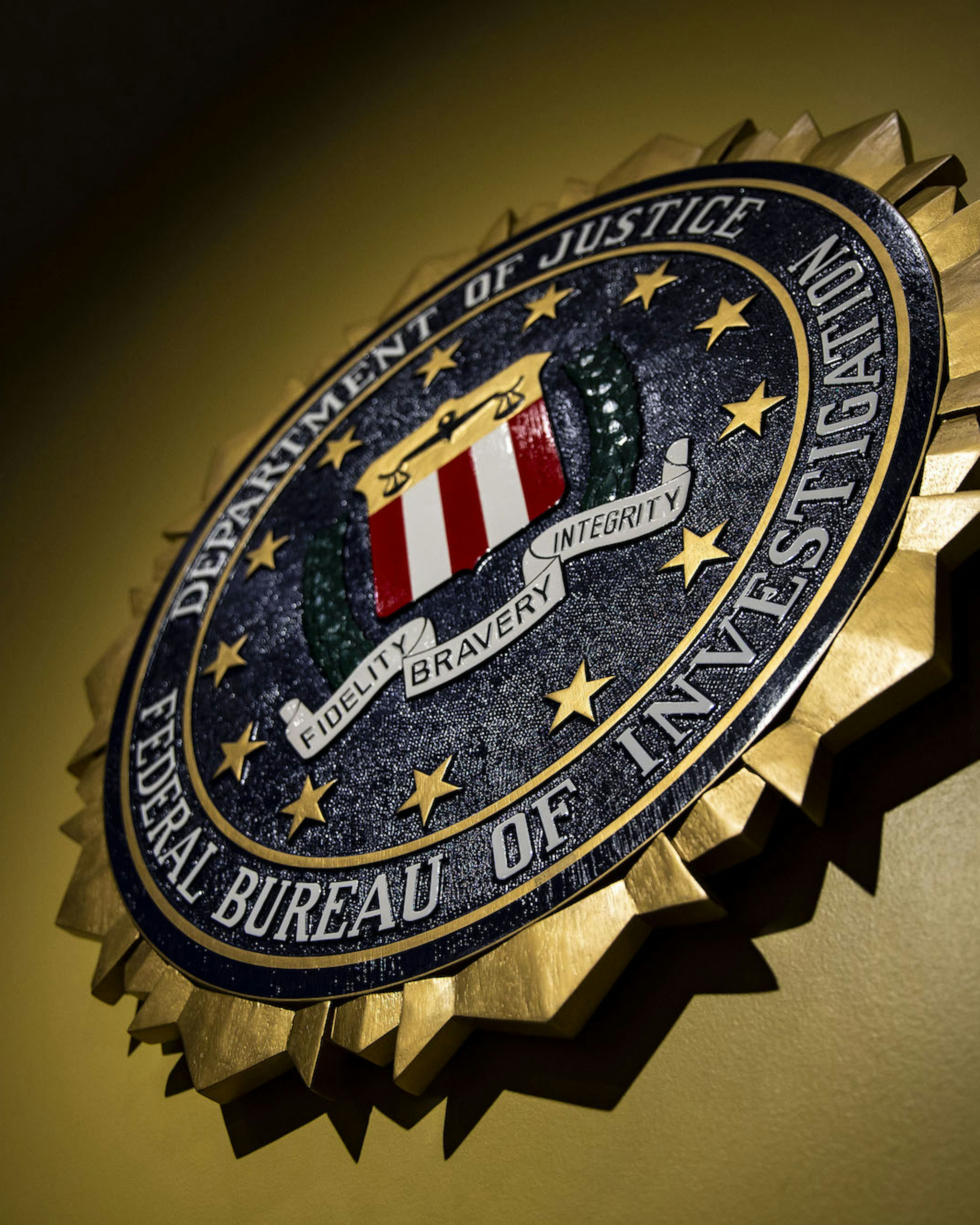 The seal of the Federal Bureau of Investigation (FBI) hangs on a wall before a news conference at the FBI headquarters in Washington, D.C.